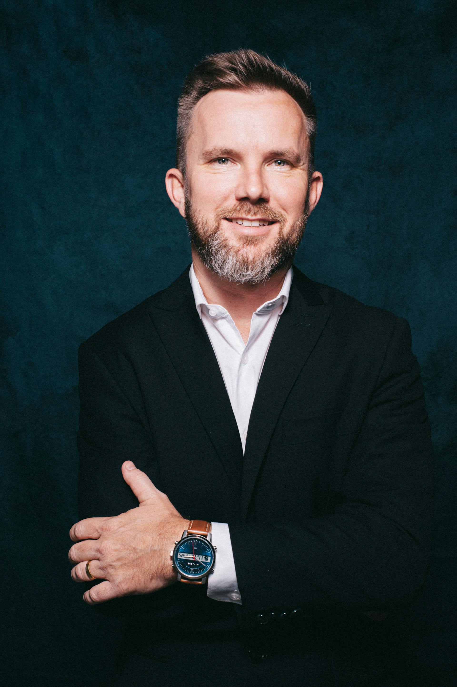 A smiling middle-aged man in a suit | Source: Pexels