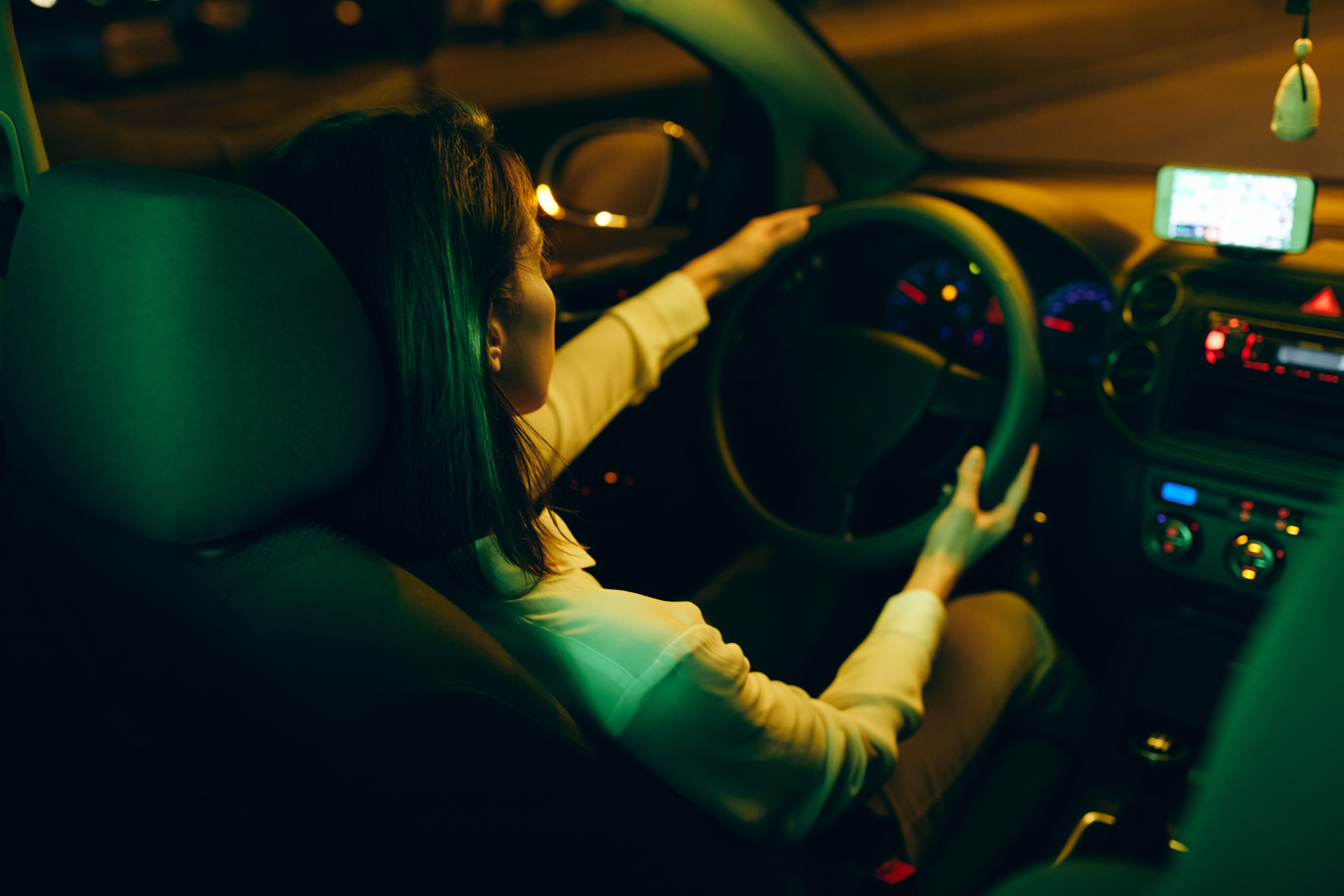 Back view of woman in night ride by her car. | Source: Shutterstock