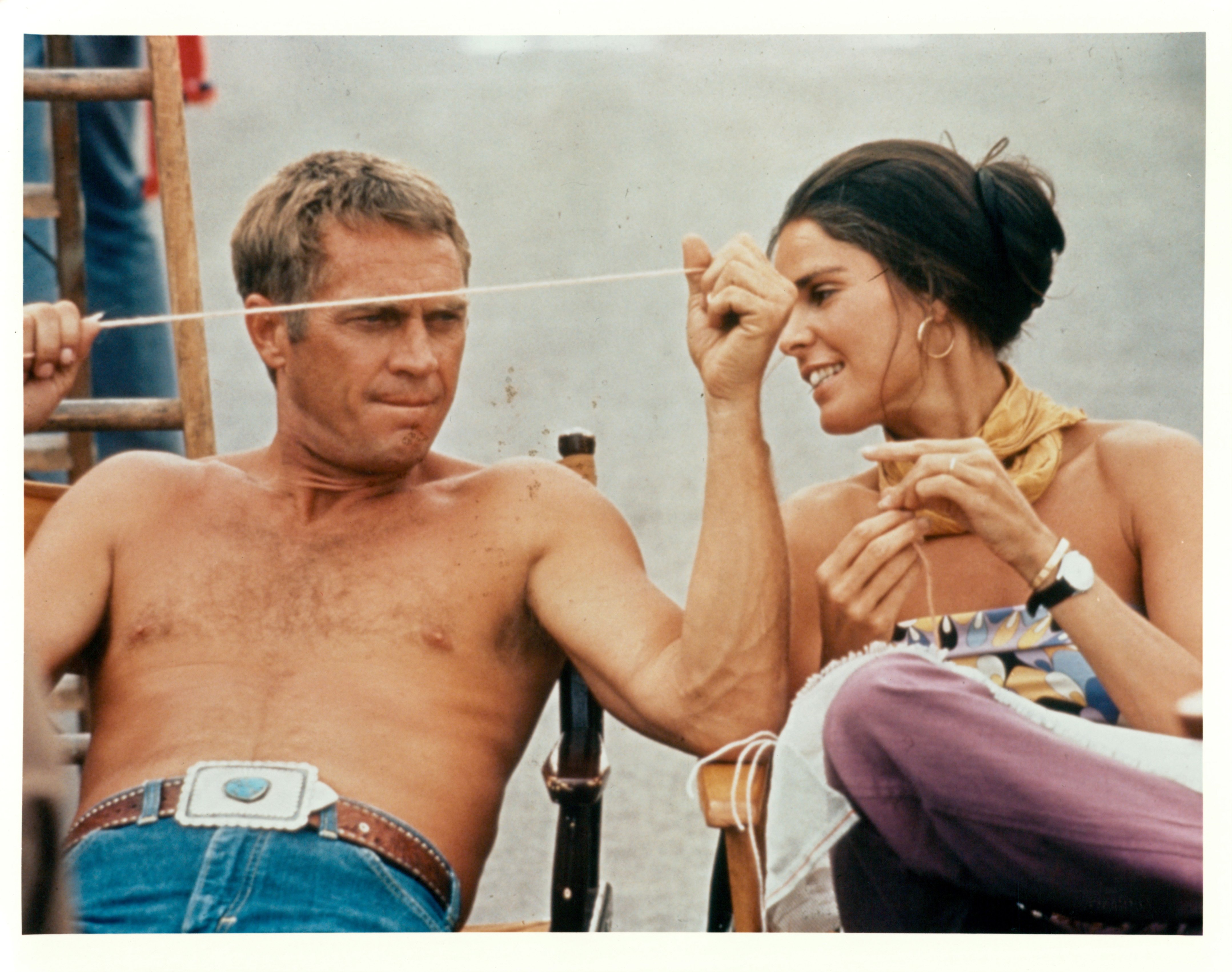 Steve McQueen and Ali MacGraw sit next to each other on the set of the 1972 film "The Getaway." | Source: Getty Images