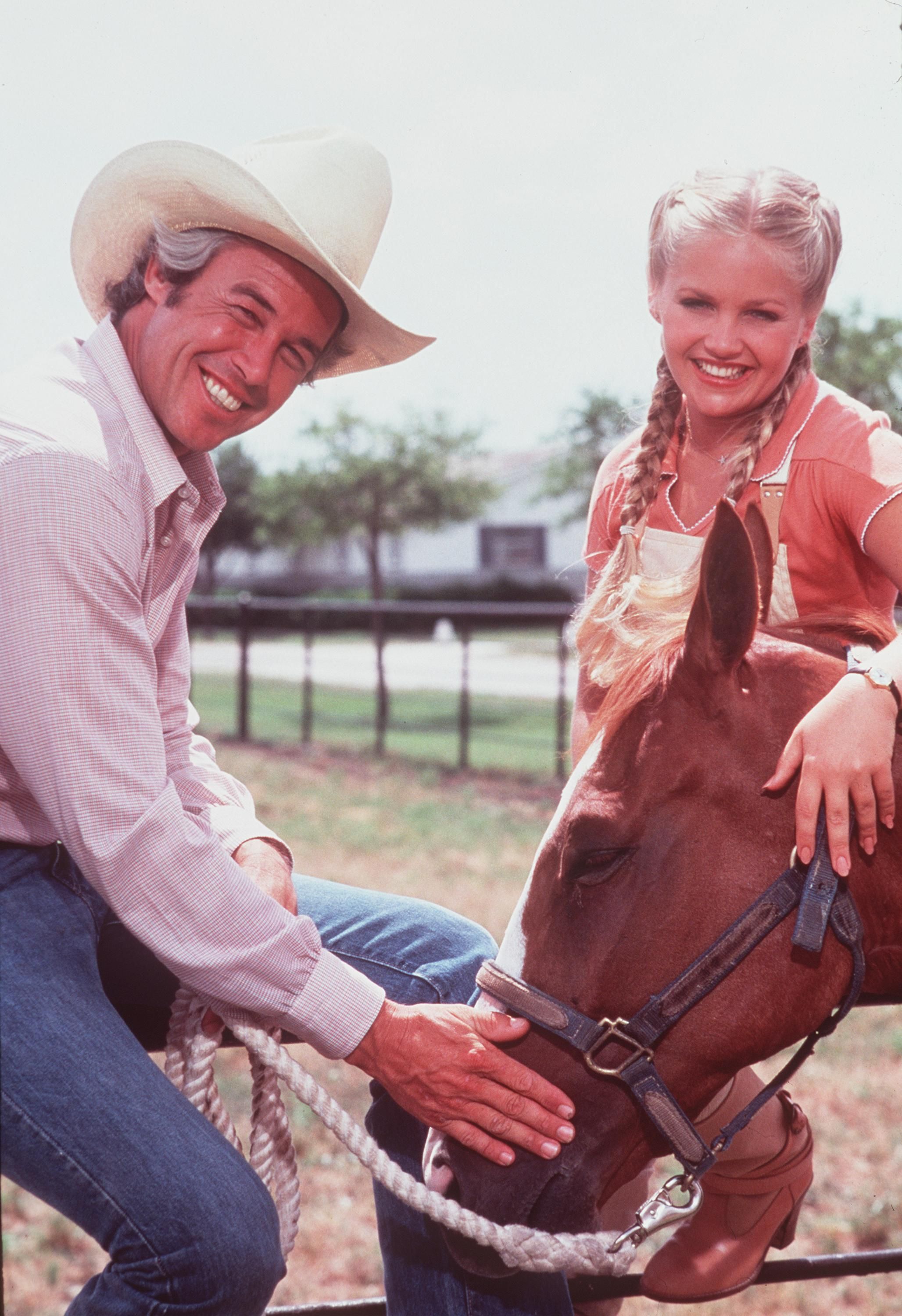 Charlene Tilton as Lucy Ewing in "Dallas" publicity stills with her co-star at an unspecified location and date. | Source: Newsmakers/Getty Images