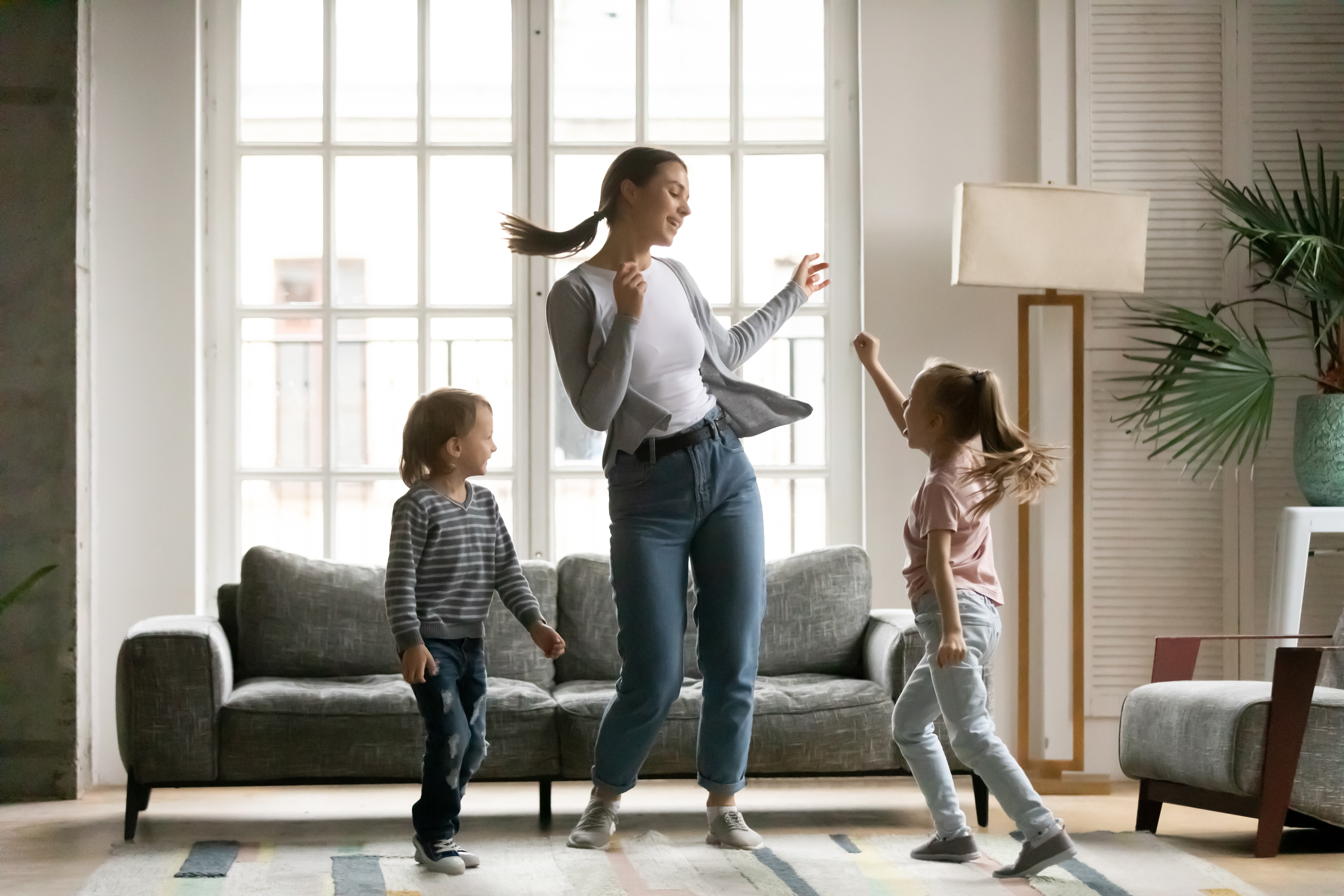 Woman playing with two children | Source: Shutterstock