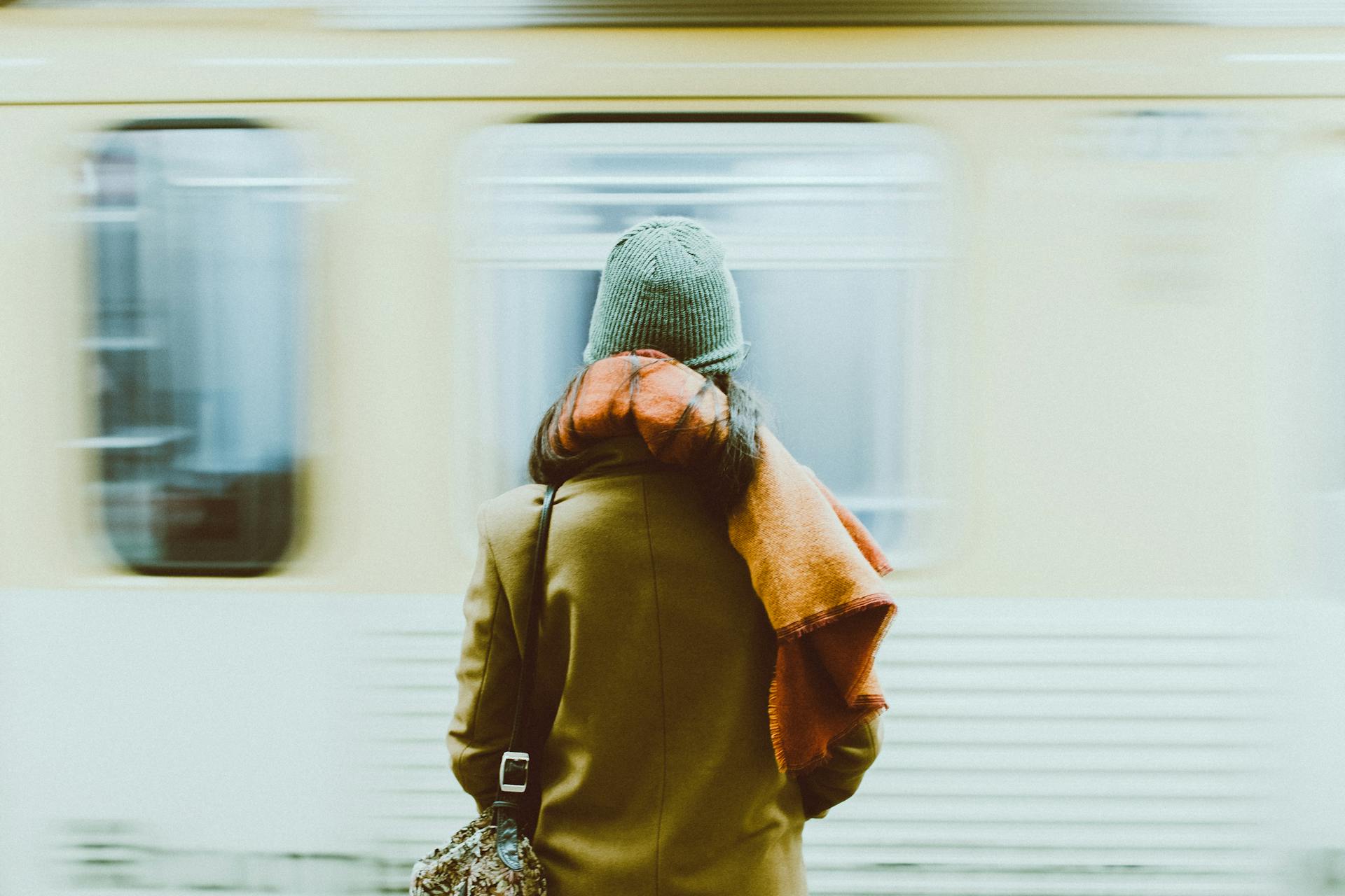 A time-lapse photo of a person standing near a train | Source: Pexels