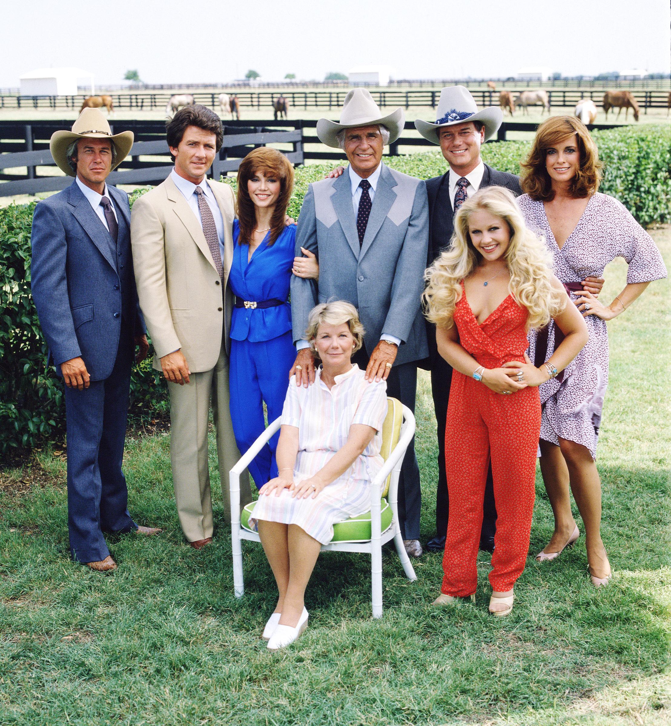 The cast of “Dallas” assembled on the property of the Southfork ranch, on the outskirts of Dallas, Texas, in 1979. From left, Steve Kanaly, Patrick Duffy, Victoria Principal, (sitting), Barbara Bel Geddes, Jim Davis, Larry Hagman, Charlene Tilton (in red), and Linda Gray | Source: Getty Images