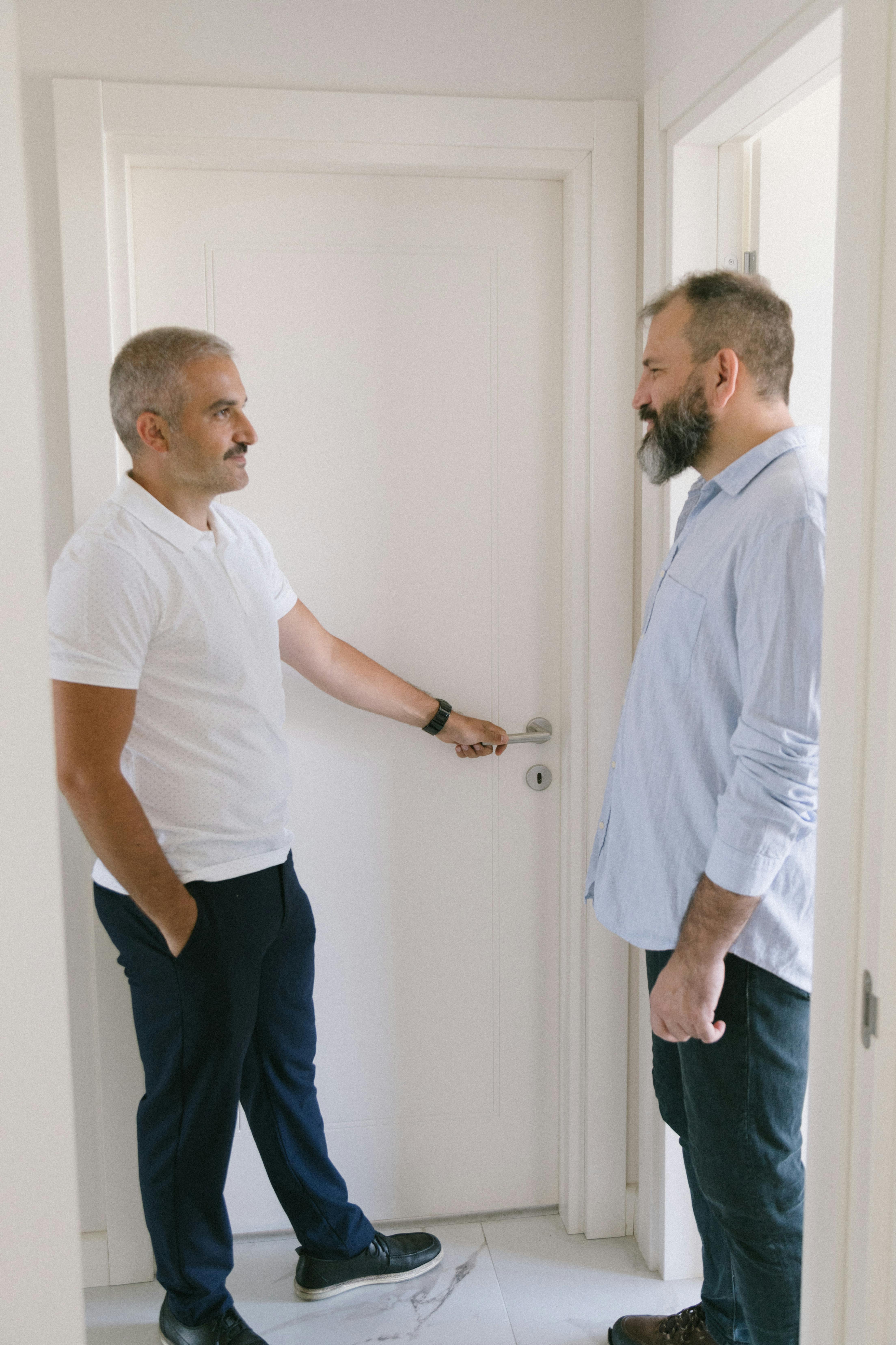 One man confronting another in a doorway | Source: Pexels