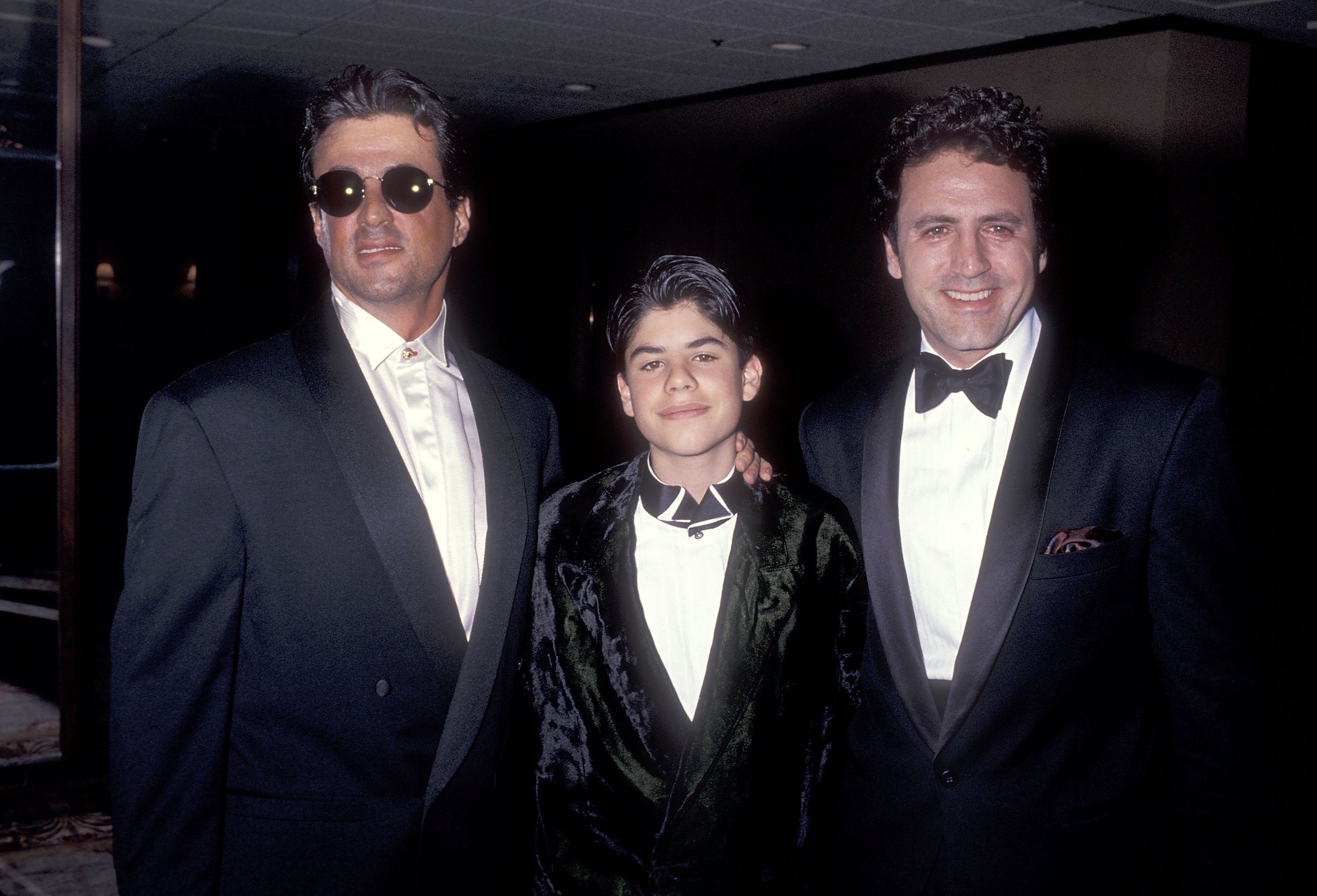 Sylvester Stallone, Sage Stallone and Frank Stallone during the California Fashion Industry Friends of AIDS Project Los Angeles Fifth Annual Fashion Show & Dinner Benefit Salute to Gianni Versace on February 13, 1991 at the Century Plaza Hotel in Century City, California. | Source: Getty Images