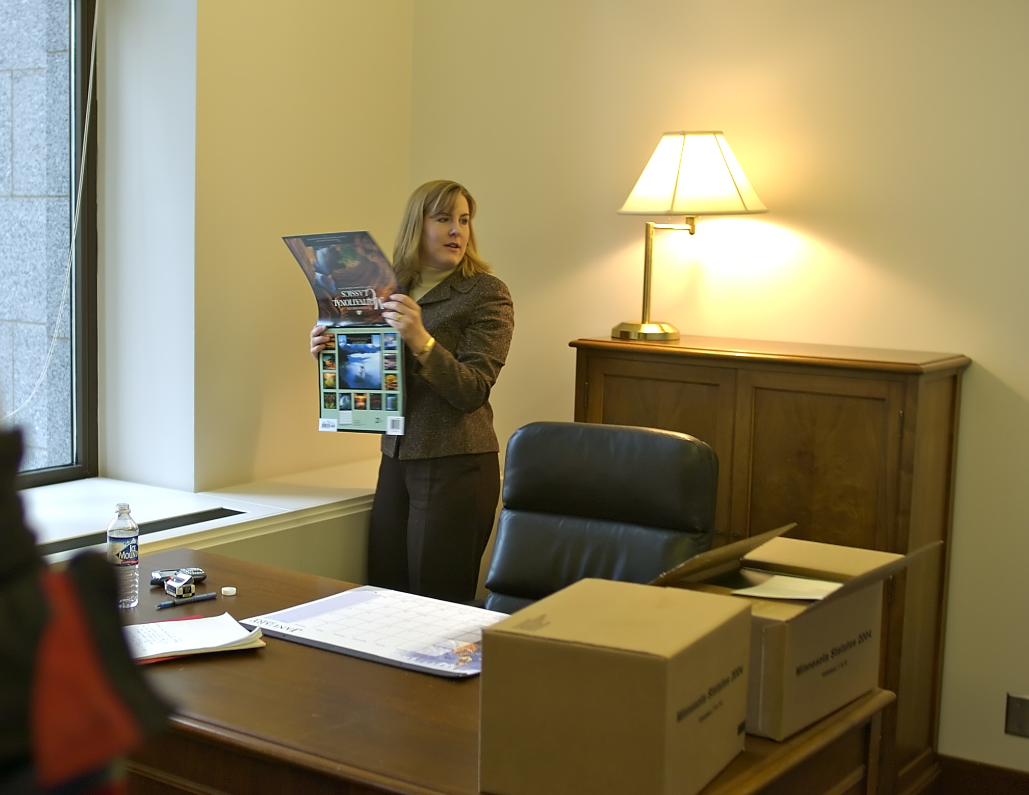 Melissa Hortman looks around for a good place to put a calendar in her new office in the State Office Building in 2004 | Source: Getty Images