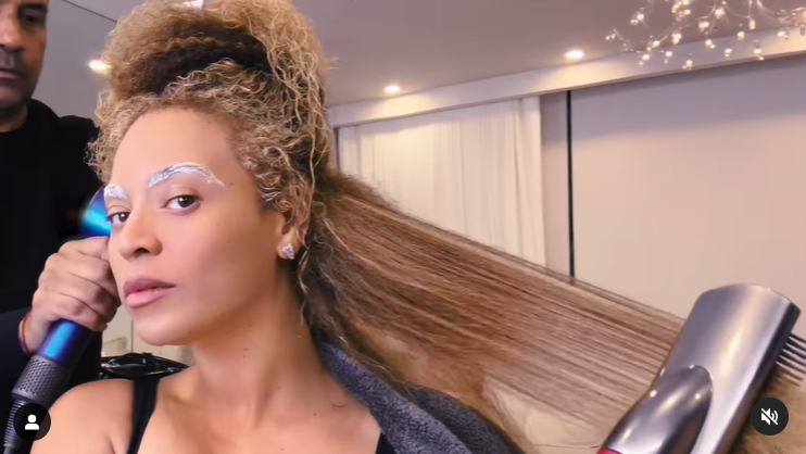 Beyoncé irons a section of her blonde hair in a video shared in April 2024. | Source: Instagram/beyonce