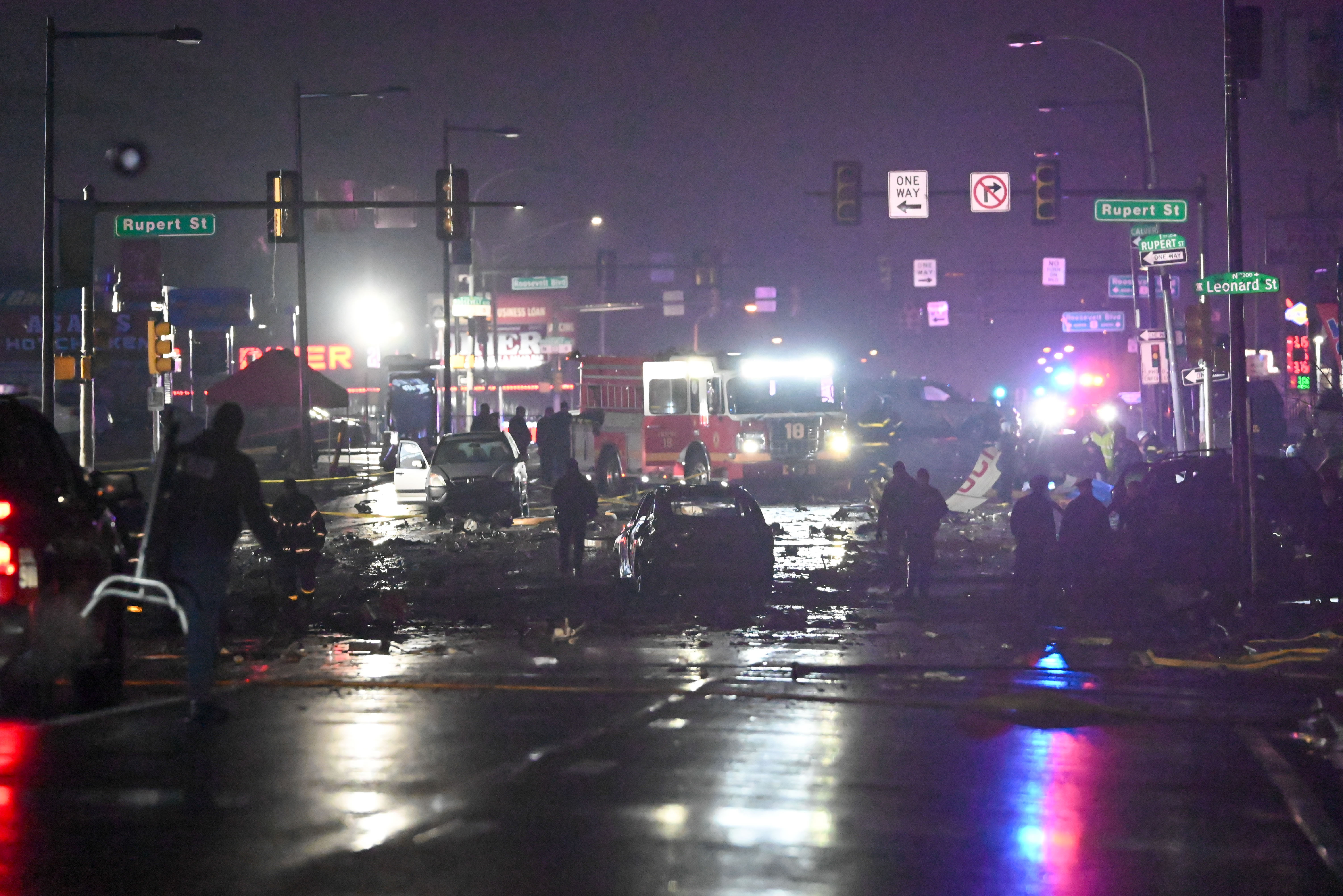 Cars and chunks of debris scattered everywhere as first responders and government officials scan the crash site. | Source: Getty Images