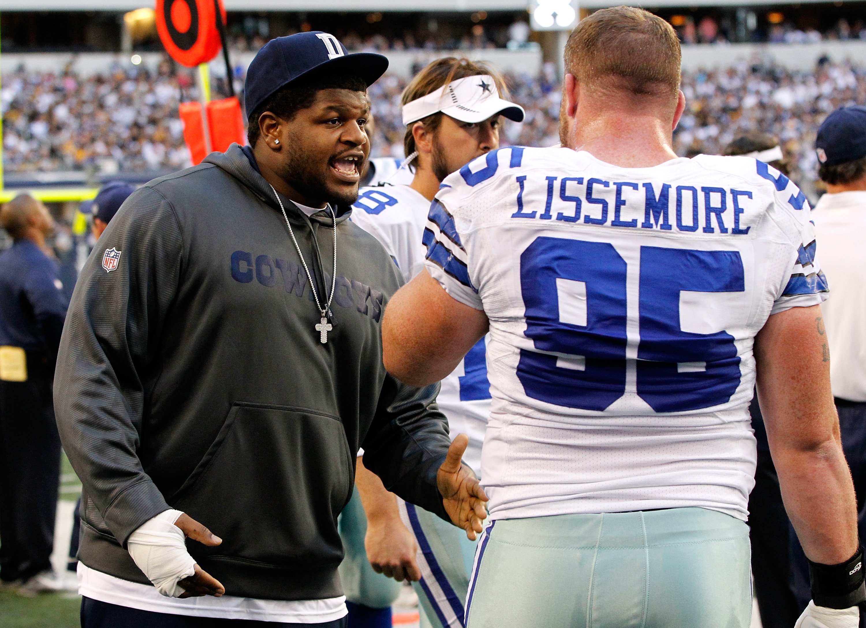 Josh Brent talks with teammate Sean Lissemore #95 at Cowboys Stadium on December 16, 2012 | Photo: Getty Images