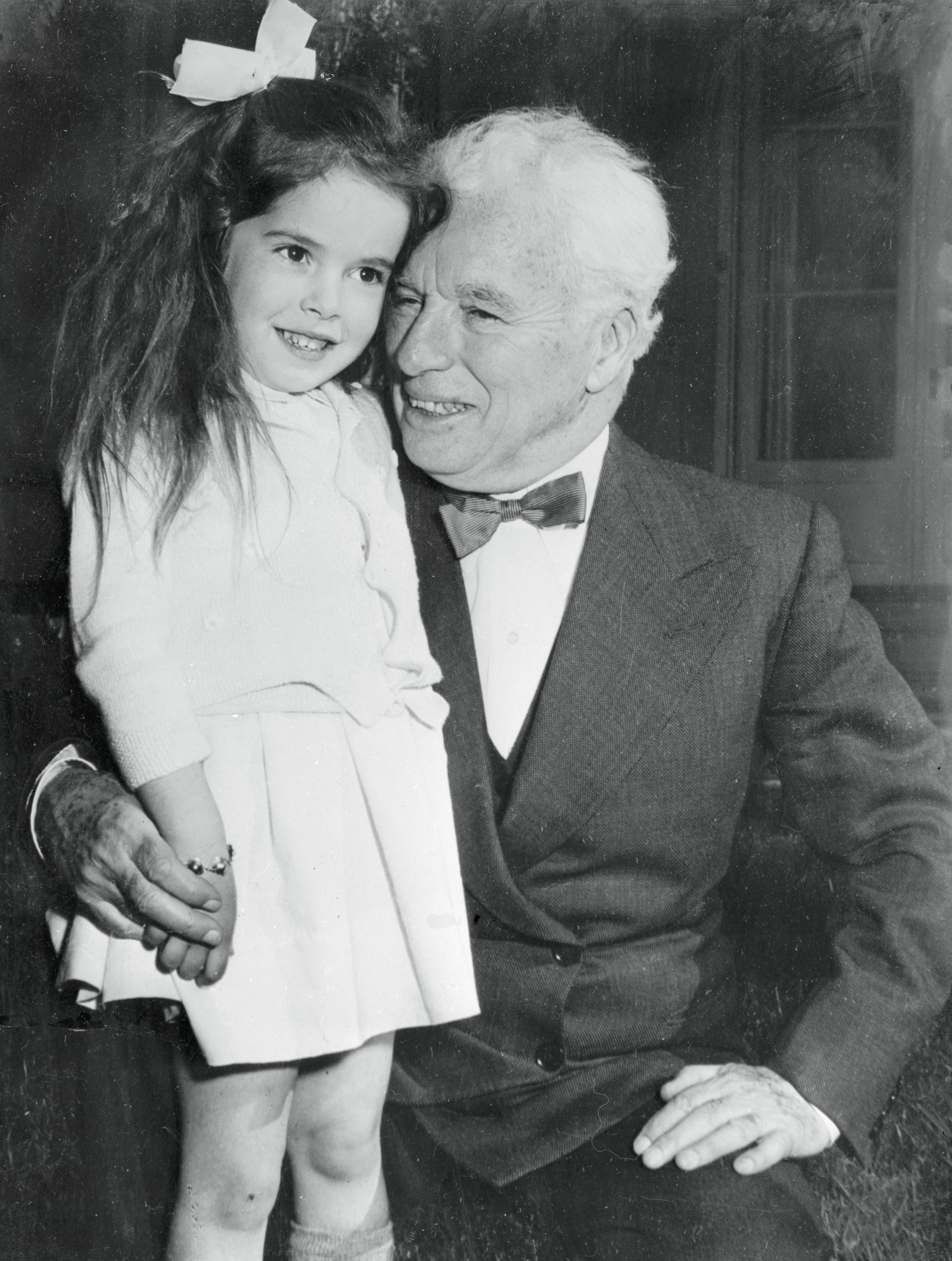 Charles Chaplin accepting a birthday hug from his daughter, Josephine, on April 18, 1954 | Source: Getty Images