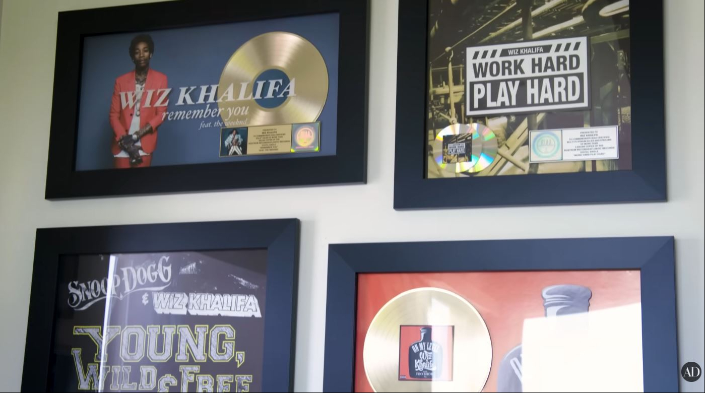 Several of Wiz Khalifa's music plaques and career achievements are showcased inside his Los Angeles home. | Source: YouTube/Architectural Digest