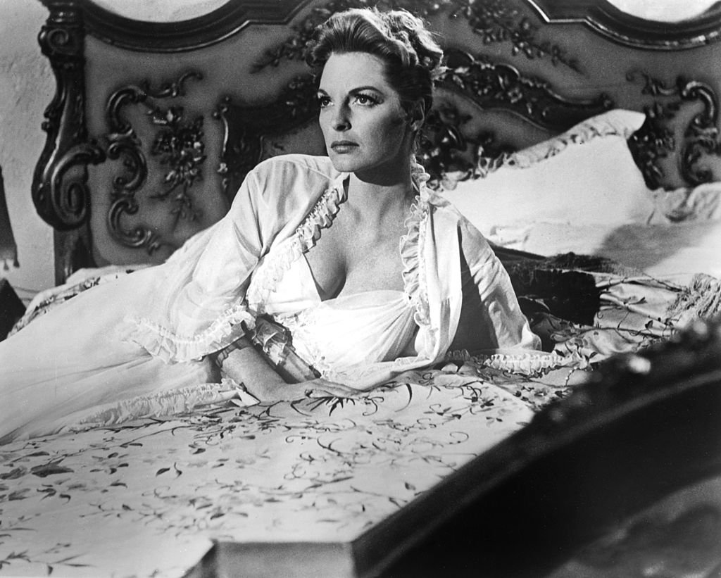 US singer and actress, Julie London wearing a white nightgown while reclining on a bed, in a studio portrait, circa 1950. | Photo: Getty Images