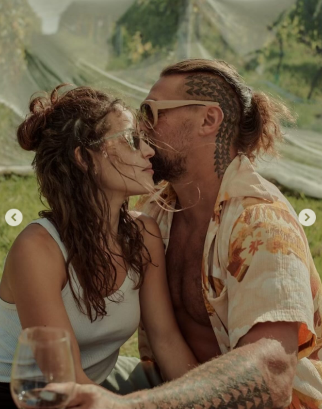 Jason Momoa and Adria Arjona are capruted in an intimate moment, from a post dated August 1, 2025. | Source: Instagram/adriaarjona