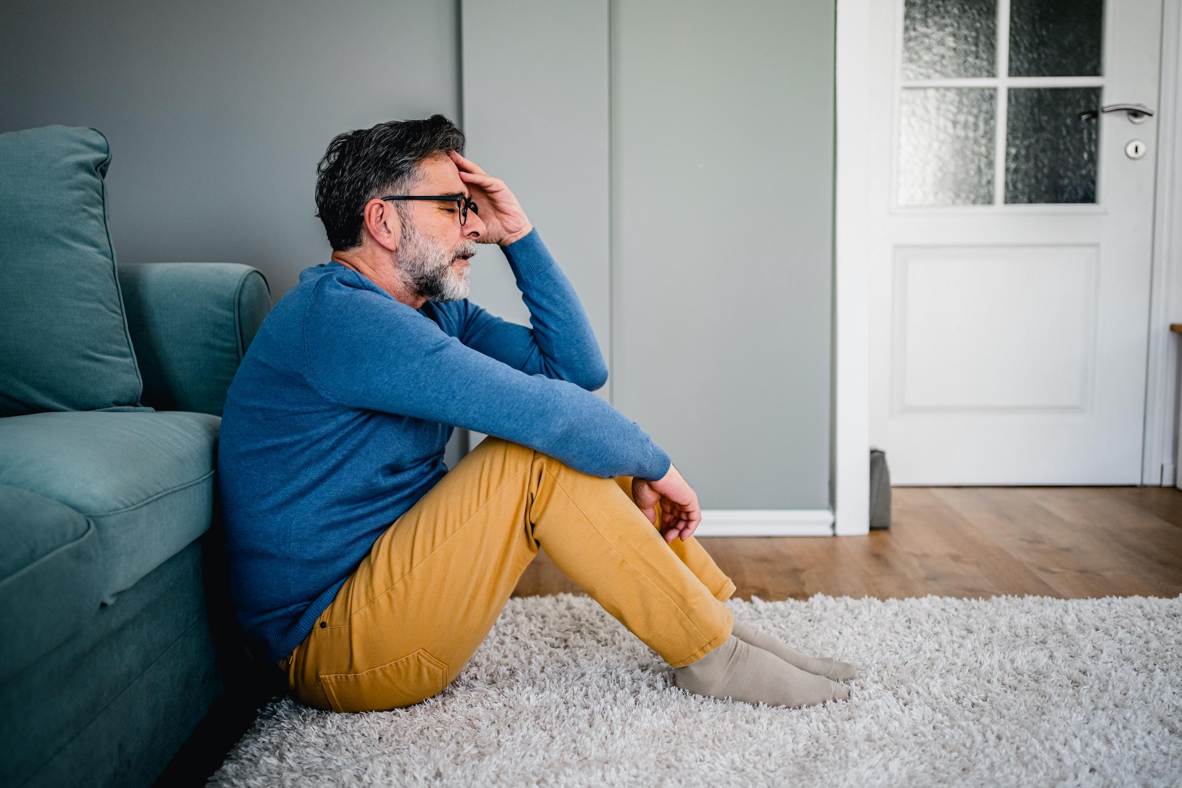 Man experiencing a headache, holding his head in discomfort | Source: Getty Images