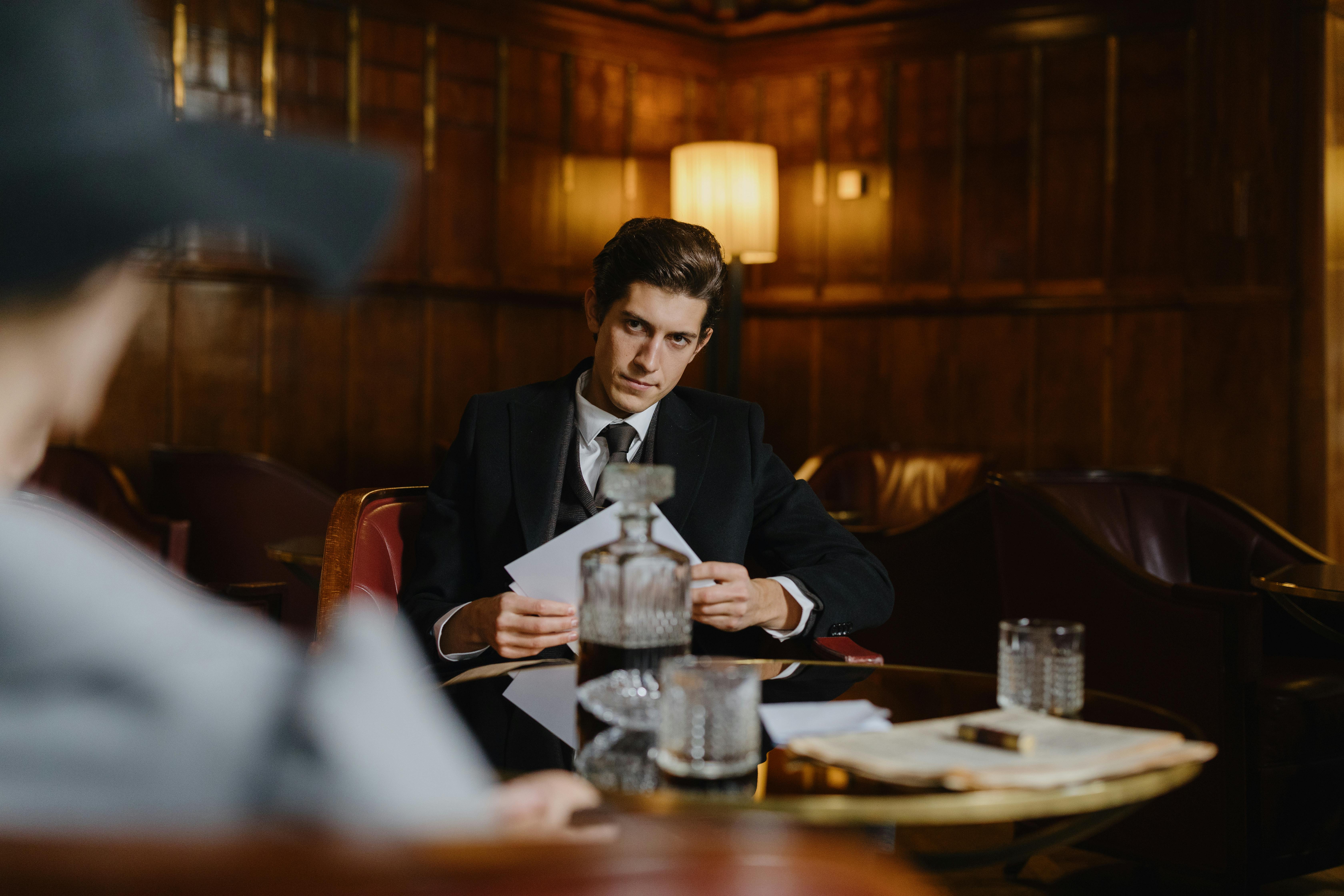 Man in a suit sitting in a restaurant | Source: Pexels