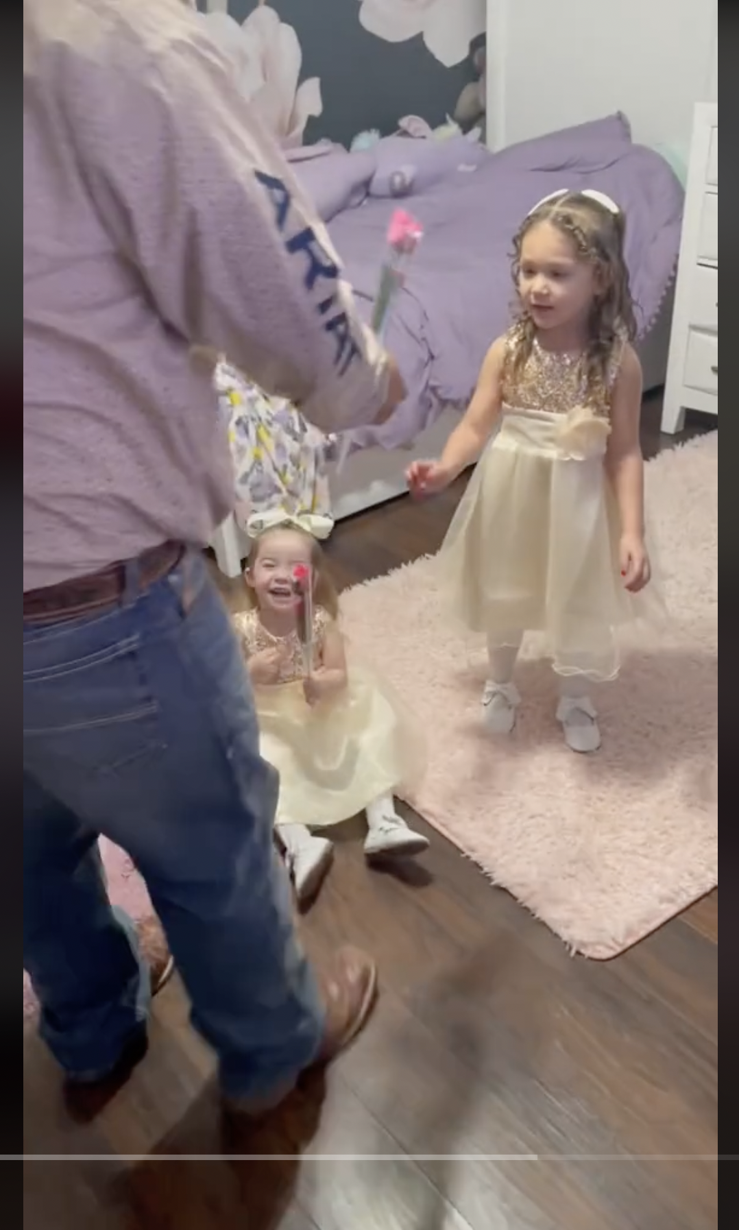 Jess Gaytan's husband is pictured giving a flower to Sophie and Genesis, as seen in a video dated May 29, 2024 | Source: TikTok/jessgaytan2