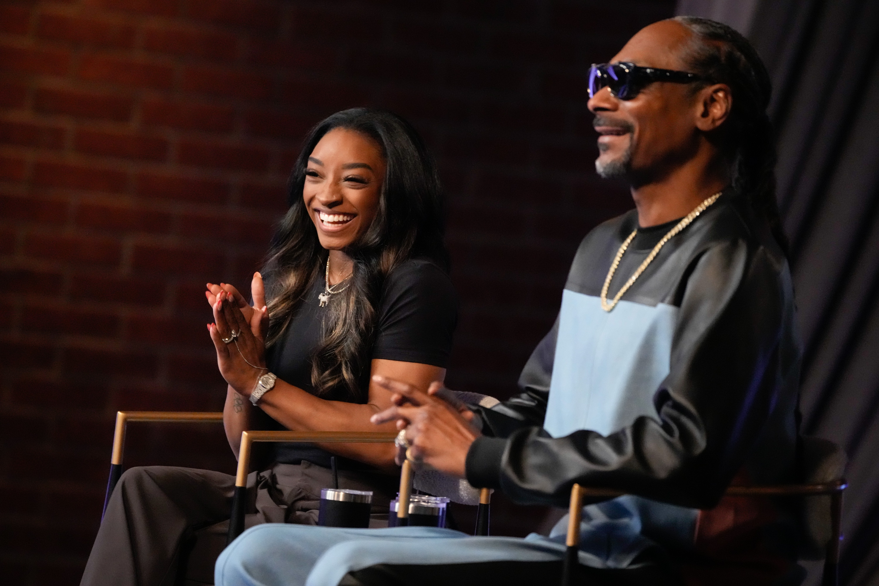 Simone Biles and Snoop Dogg posing for a picture during the taping of a season 26 episode of "The Voice" in 2024. | Source: Getty Images