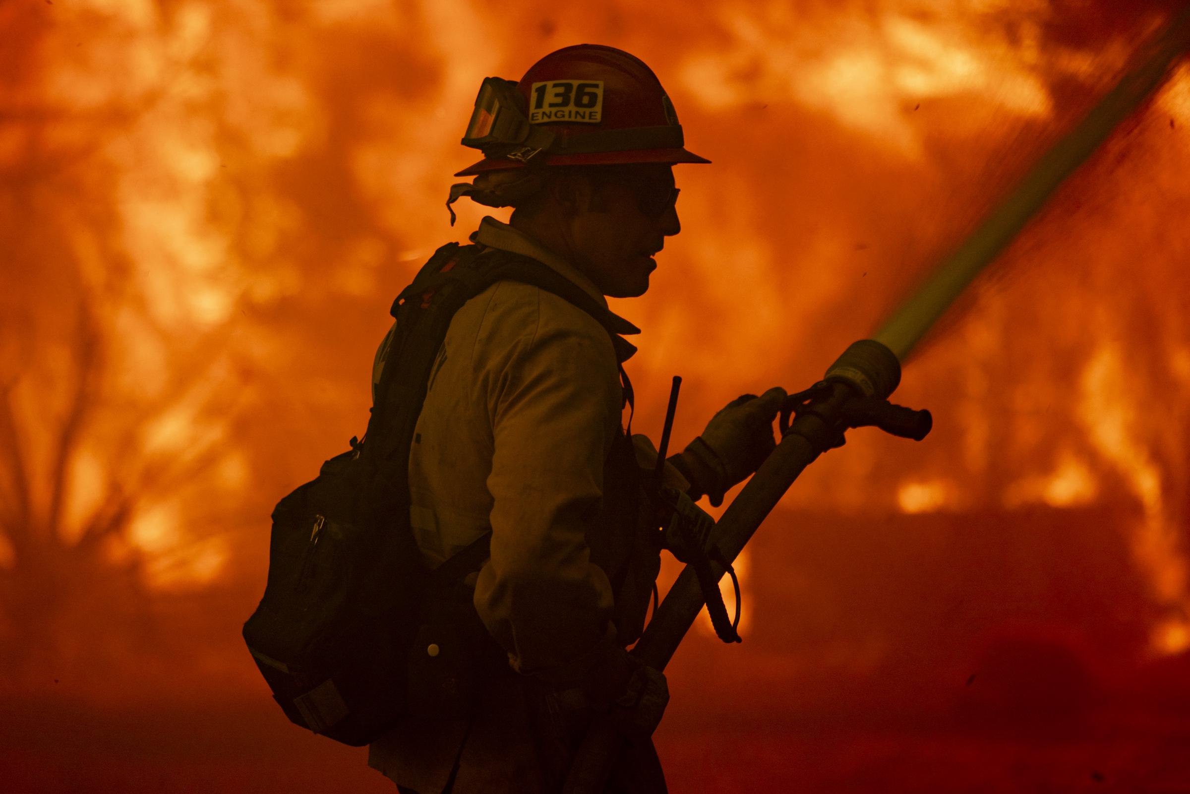 A firefighter attempting to put out the Mountain Fire flames. | Source: Getty Images