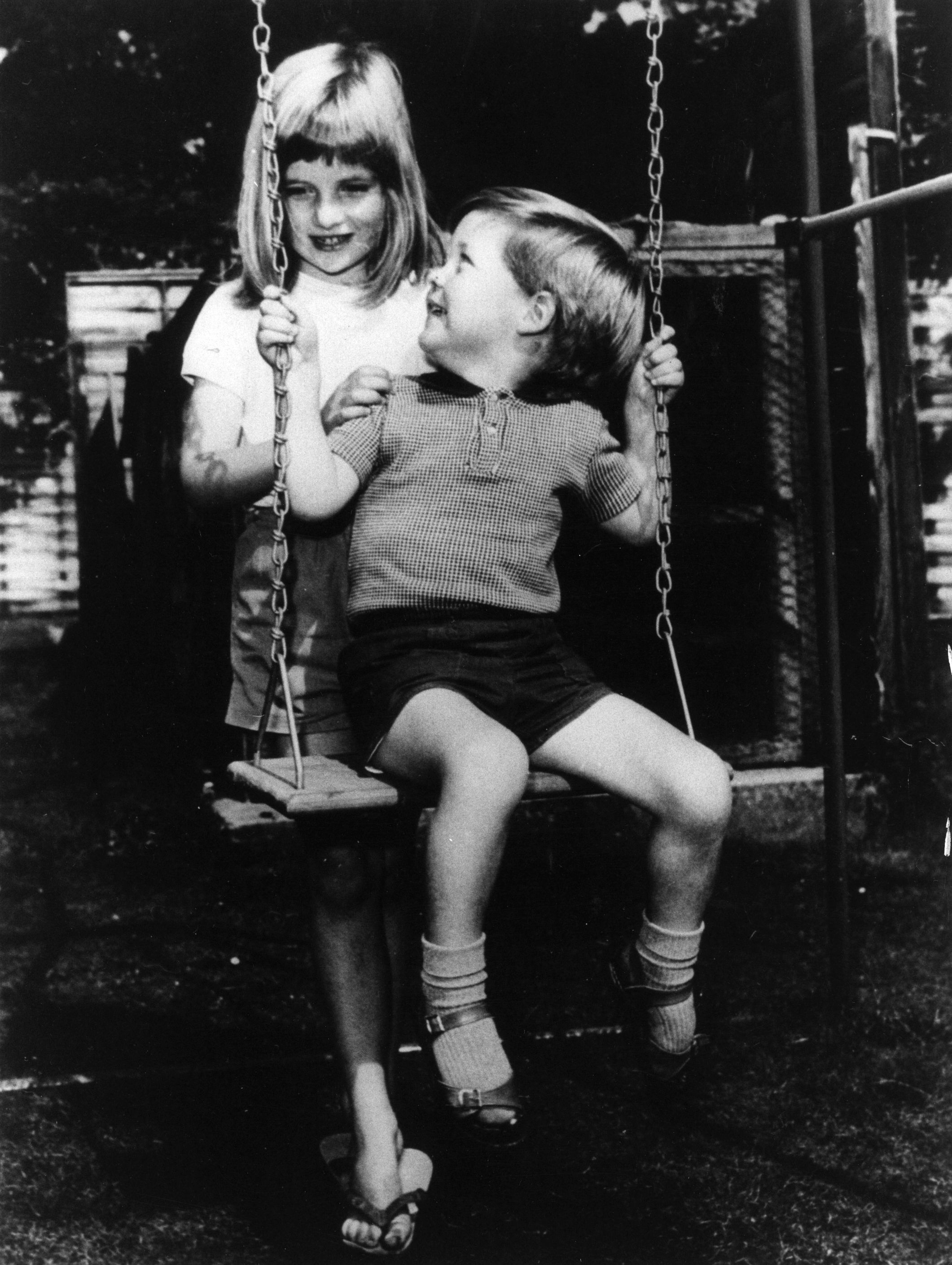 Lady Diana Spencer pictured playing with her brother Charles Edward, the Viscount Althorp, in the grounds of Park House, Sandringham. / Source: Getty Images