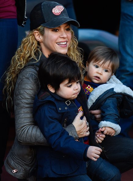 Shakira carries her children Milan and Sasha ahead of the La Liga match between FC Barcelona and Real Sociedad de Futbol at Camp Nou on November 28, 2015, in Barcelona, Spain. | Source: Getty Images.