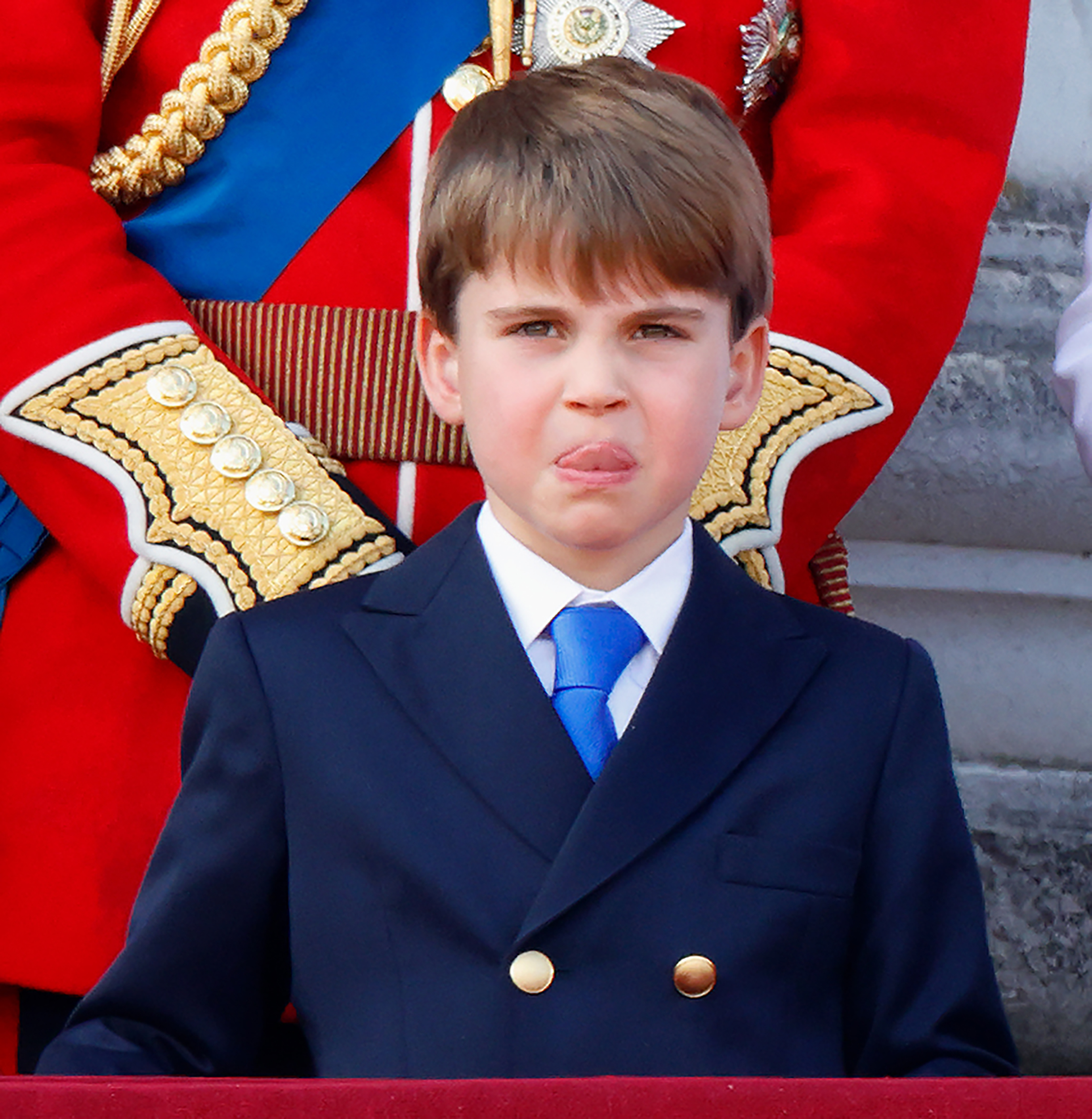 Prince Louis sticks his tongue out as he watches the Royal Air Force flypast from Buckingham Palace's balcony after Trooping the Colour in London on June 15, 2024. | Source: Getty Images