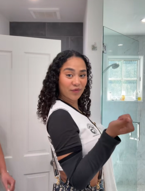 Turning slightly to the side, Brianna McKnight gestures with one hand while looking back toward the camera, from a post dated February 8, 2025. | Source: TikTok/brimcknighttt