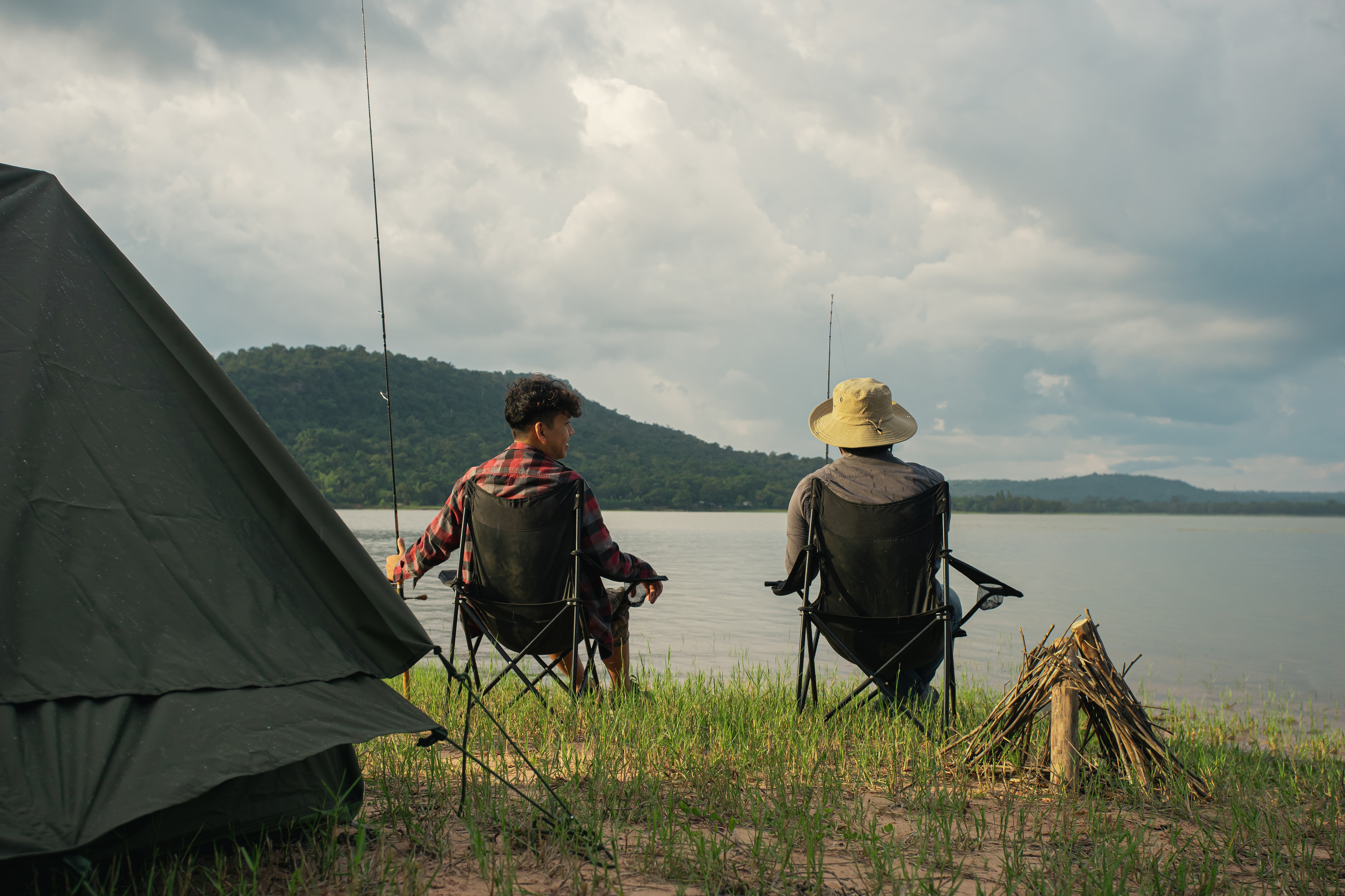 Two men fishing by a lake | Source: Shutterstock