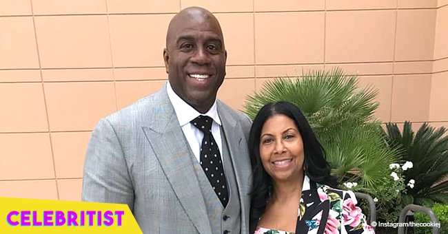 Magic and Cookie Johnson are all smiles posing next to his oldest son Andre and his wife