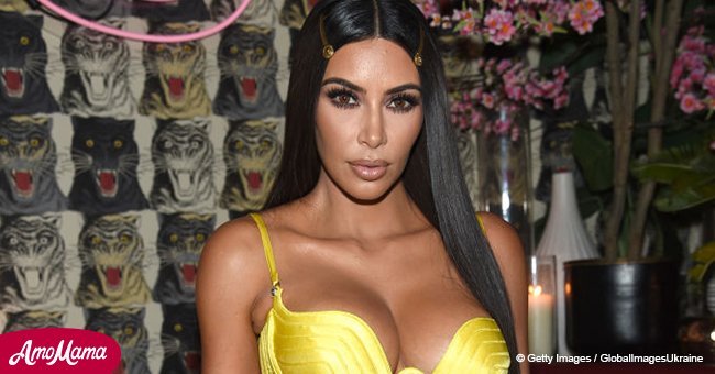 Kim Kardashian shows off her assets in a high-cut yellow gown