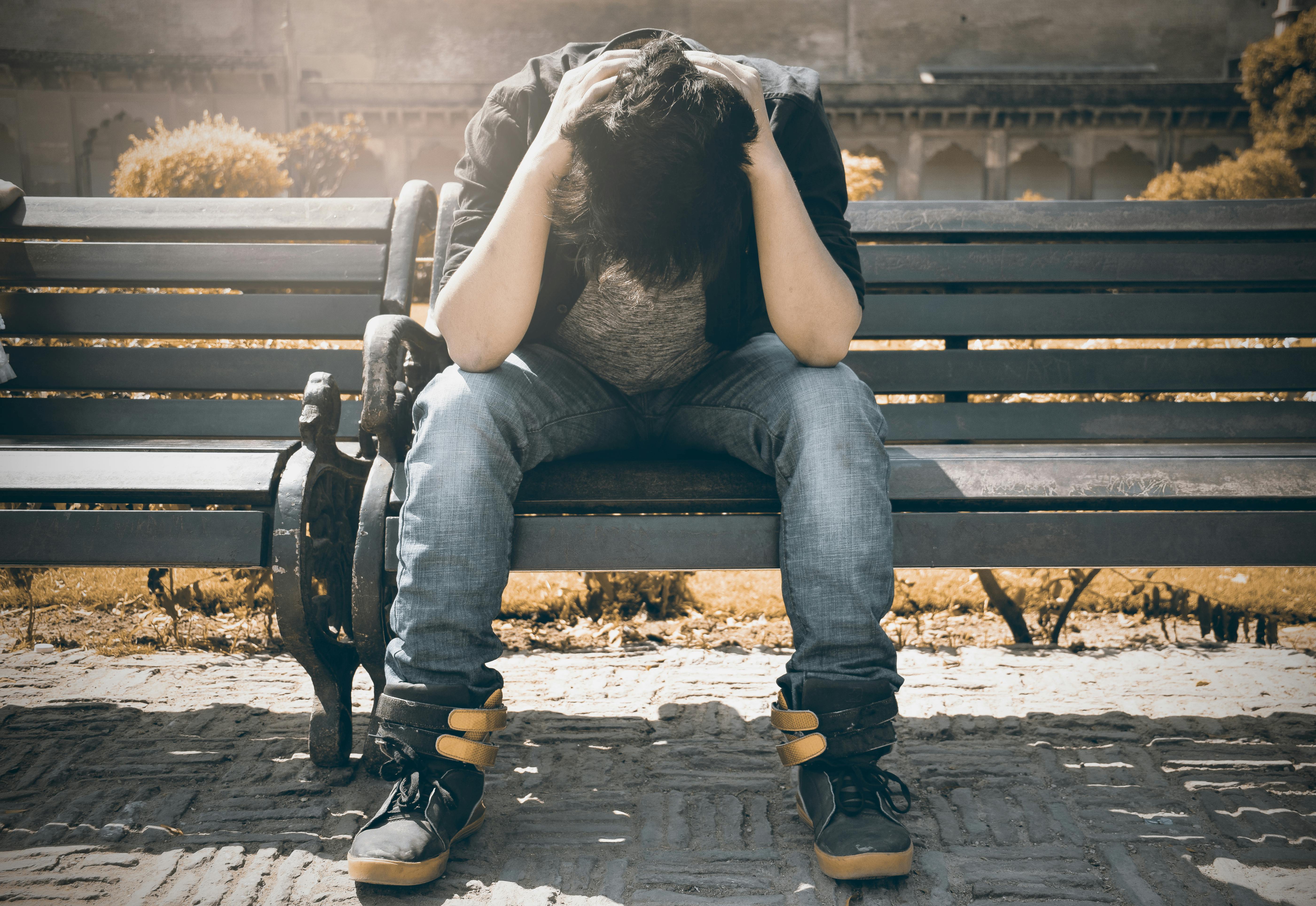 A man sitting on a bench | Source: Pexels