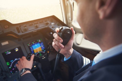 A pilot talking over a radio. | Source: Shutterstock.