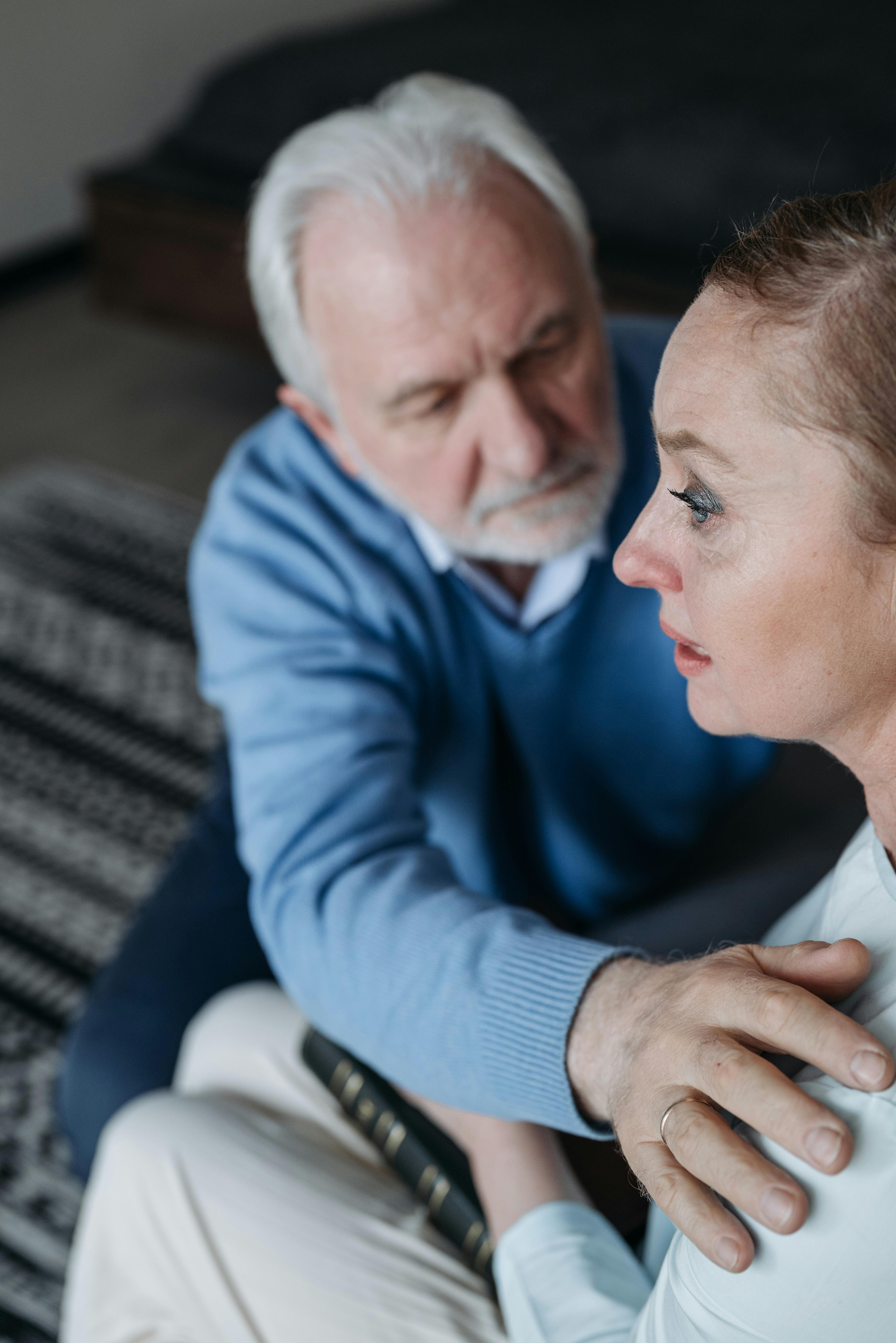 An upset senior woman being comforted by her husband | Source: Pexels