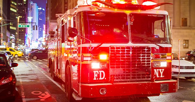 A FDNY firetruck shining brightly in a city scene. | Photo: Shutterstock