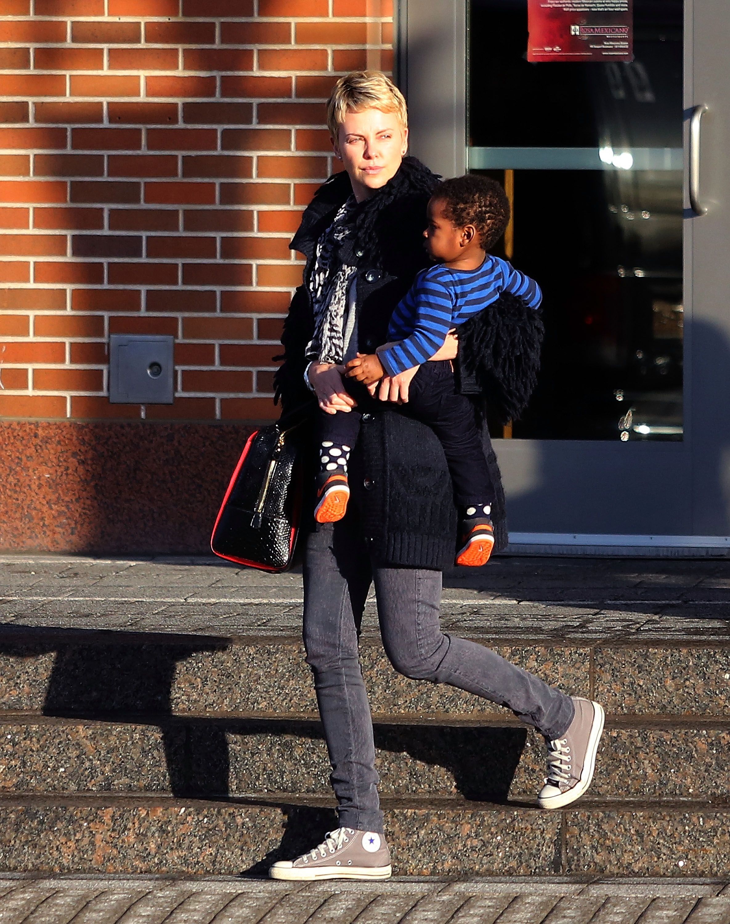 Charlize Theron with Jackson Theron on March 24, 2013, in Boston, Massachusetts | Photo: Stickman/Bauer-Griffin/GC Images