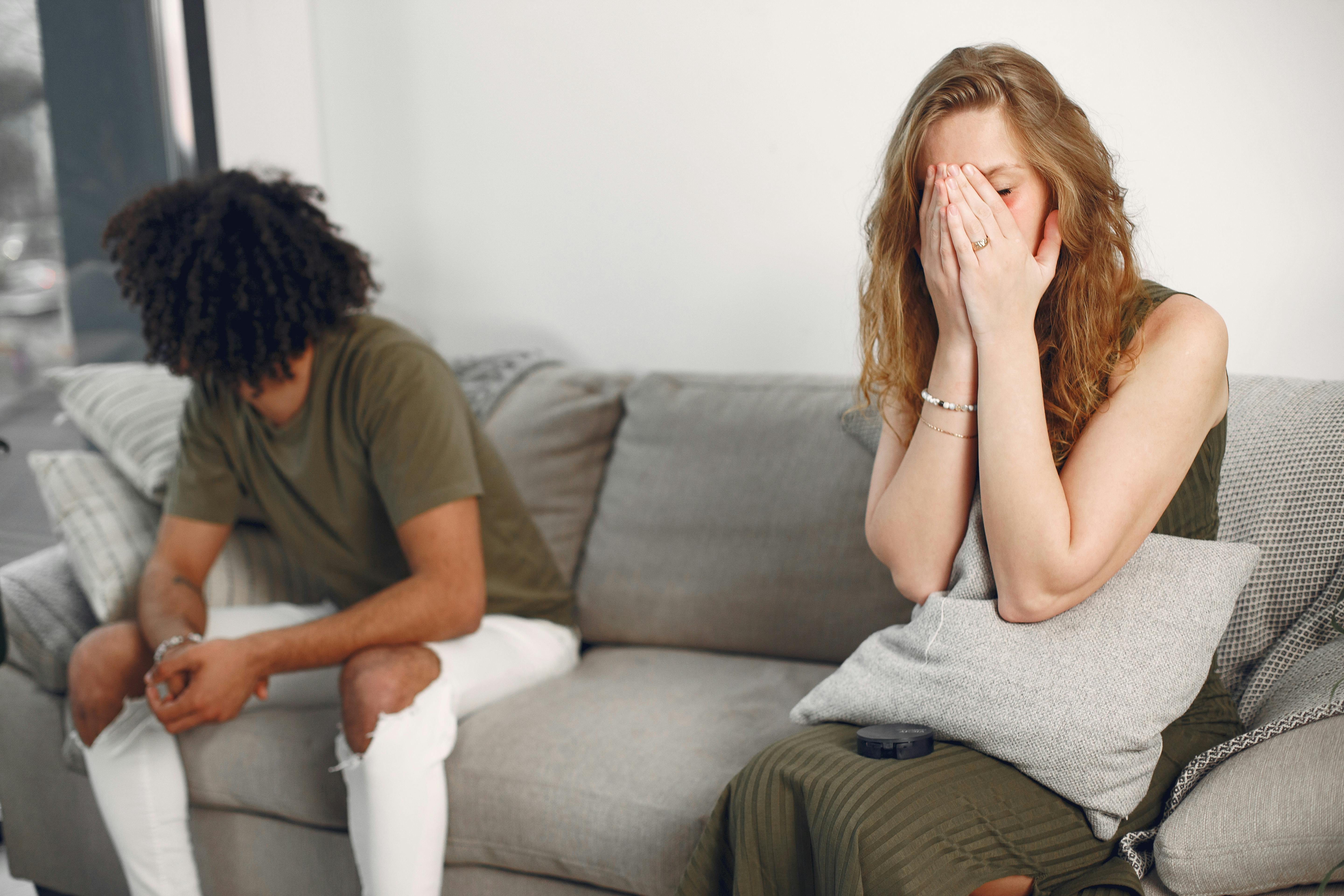 A distant couple sitting on a sofa | Source: Pexels