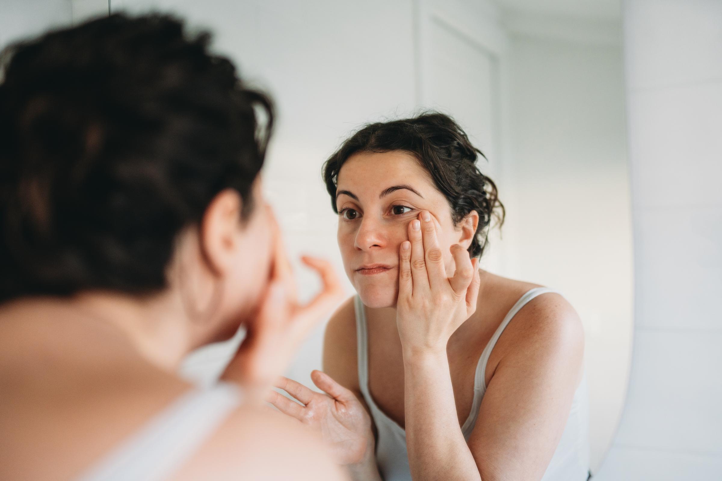 A woman checking her face for wrinkles | Source: Getty Images