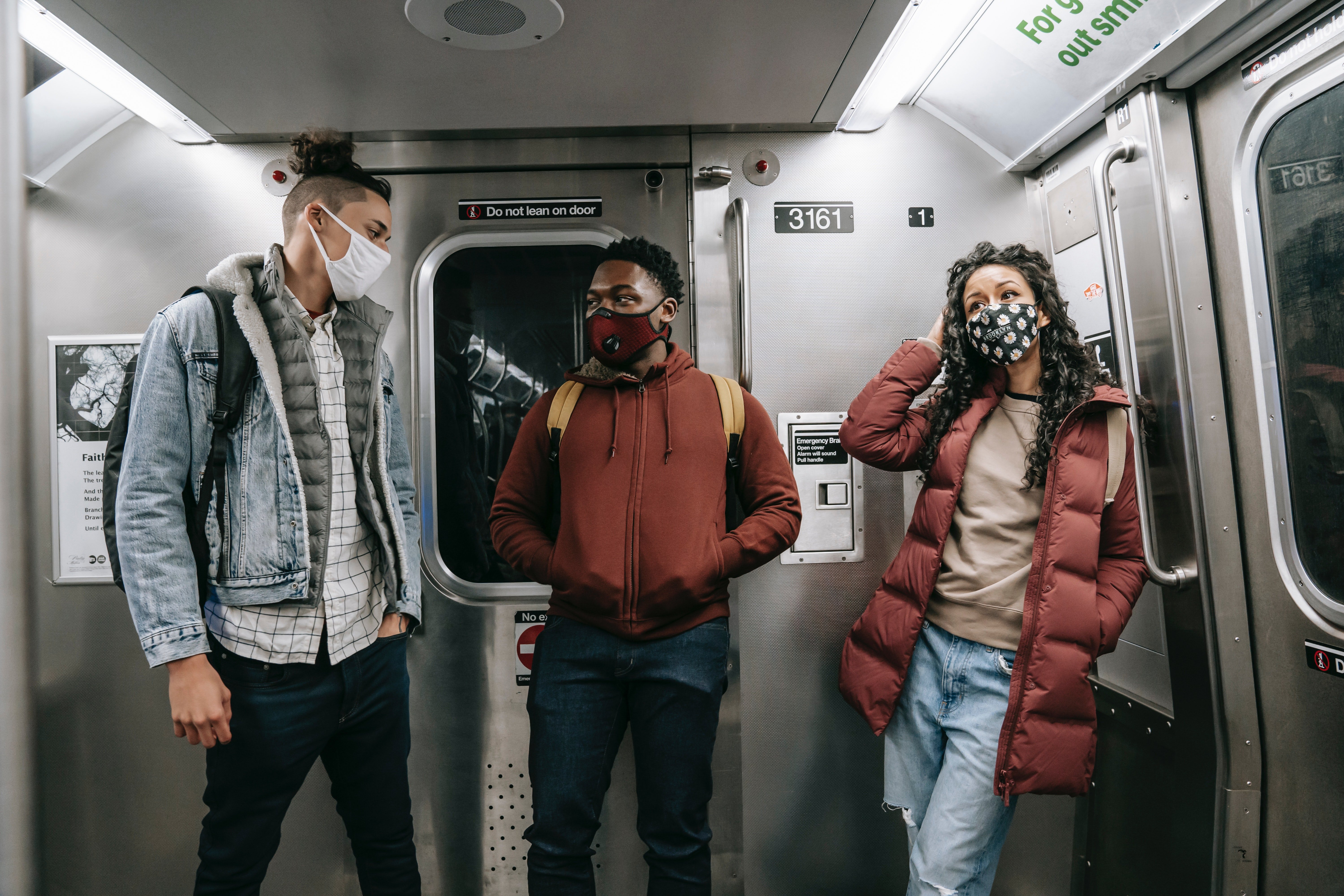 Pictured - Three friends wearing masks on a subway train | Source: Pexels 