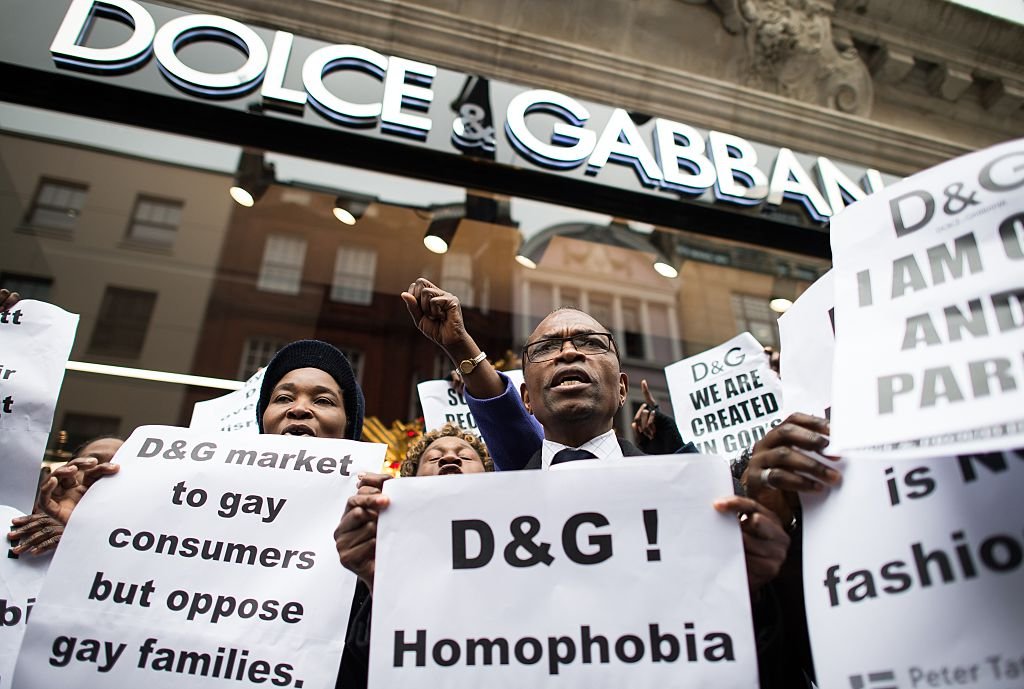 Protesters hold up placards outside a branch of Dolce and Gabbana to demonstrate against comments made by the designers regarding same-sex couples, March 2015 | Source: Getty Images