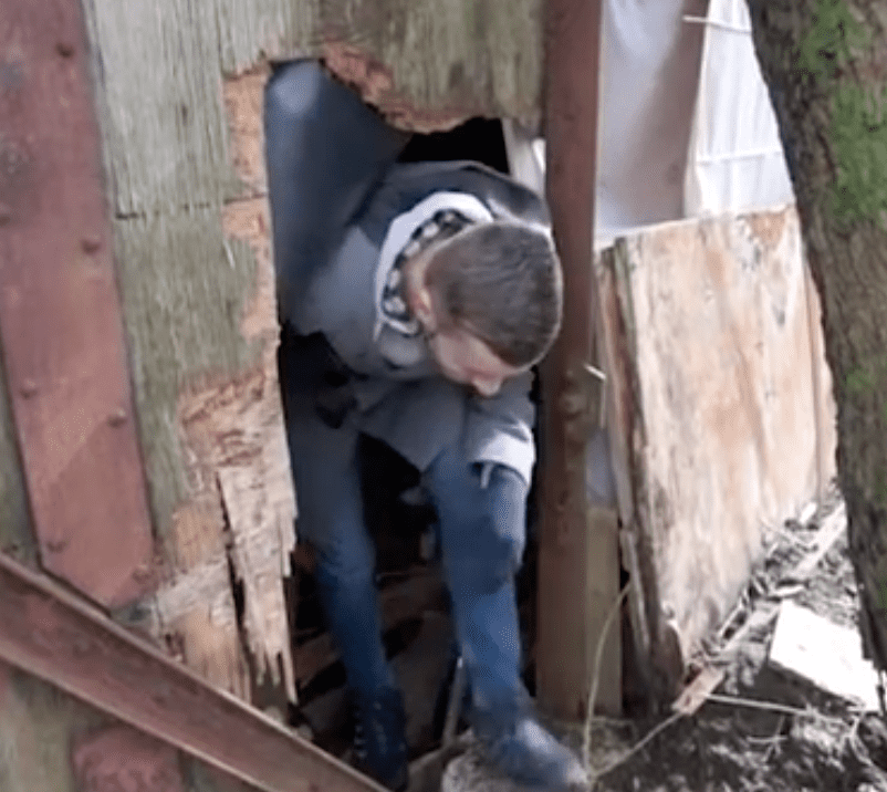 Keiran Kilday climbs out of the train carriage he lived in | Photo: youtube.com/Wales Online