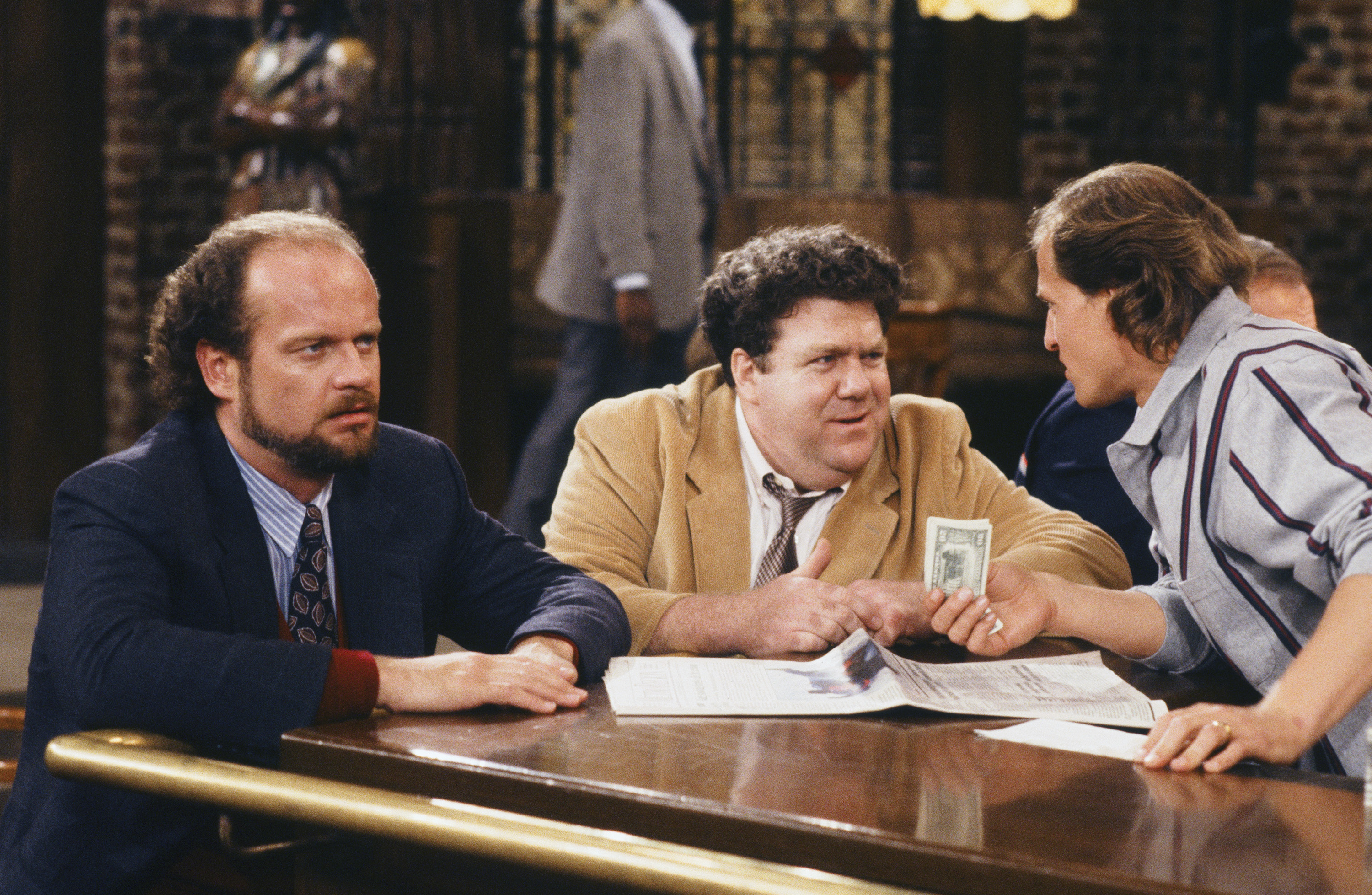Kelsey Grammer as Dr. Frasier Crane, George Wendt as Norm Peterson, and Woody Harrelson as Woody Boyd in "Cheers," circa 1993 | Source: Getty Images