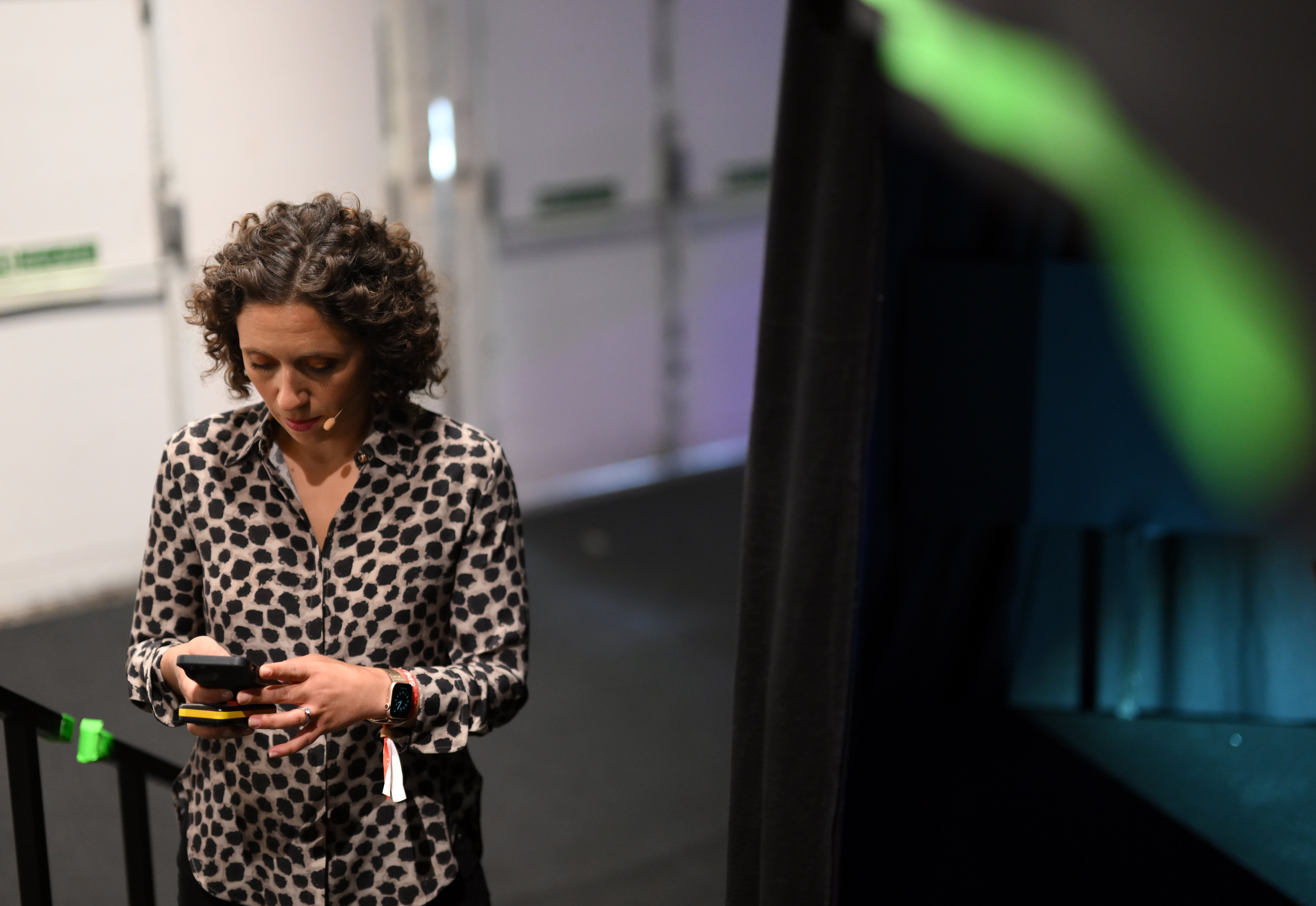 Julie Pace on her phone during the summit. | Source: Getty Images