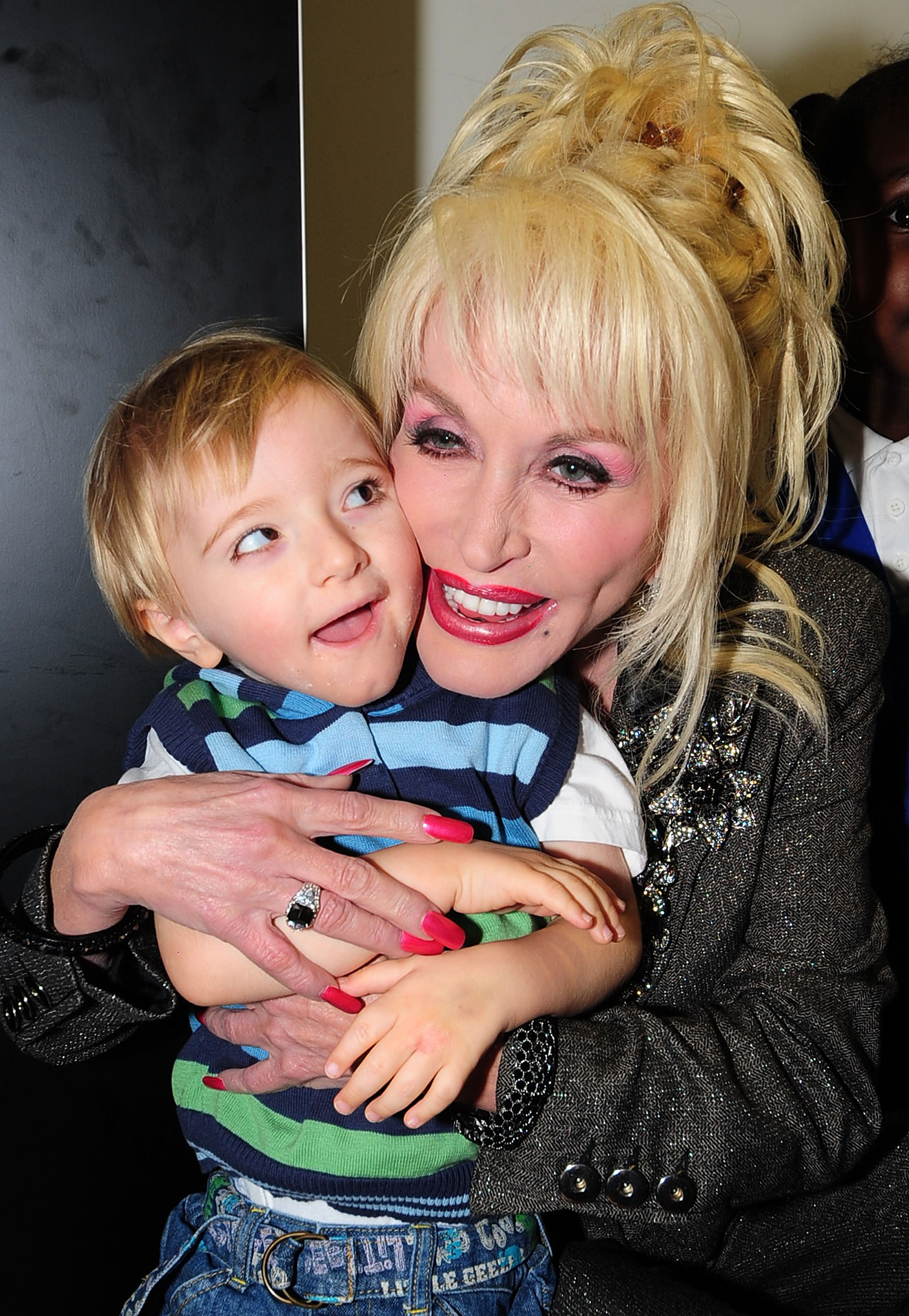 Dolly Parton meets a young child at the Magna Science and Adventure Park in Rotherham, South Yorkshire, England, on December 5, 2007. | Source: Getty Images