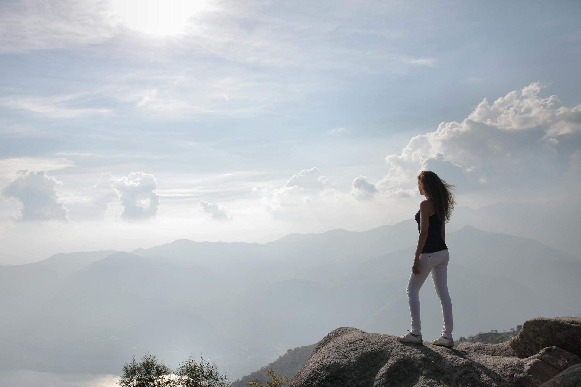 A woman standing on a rock | Source: Pexels