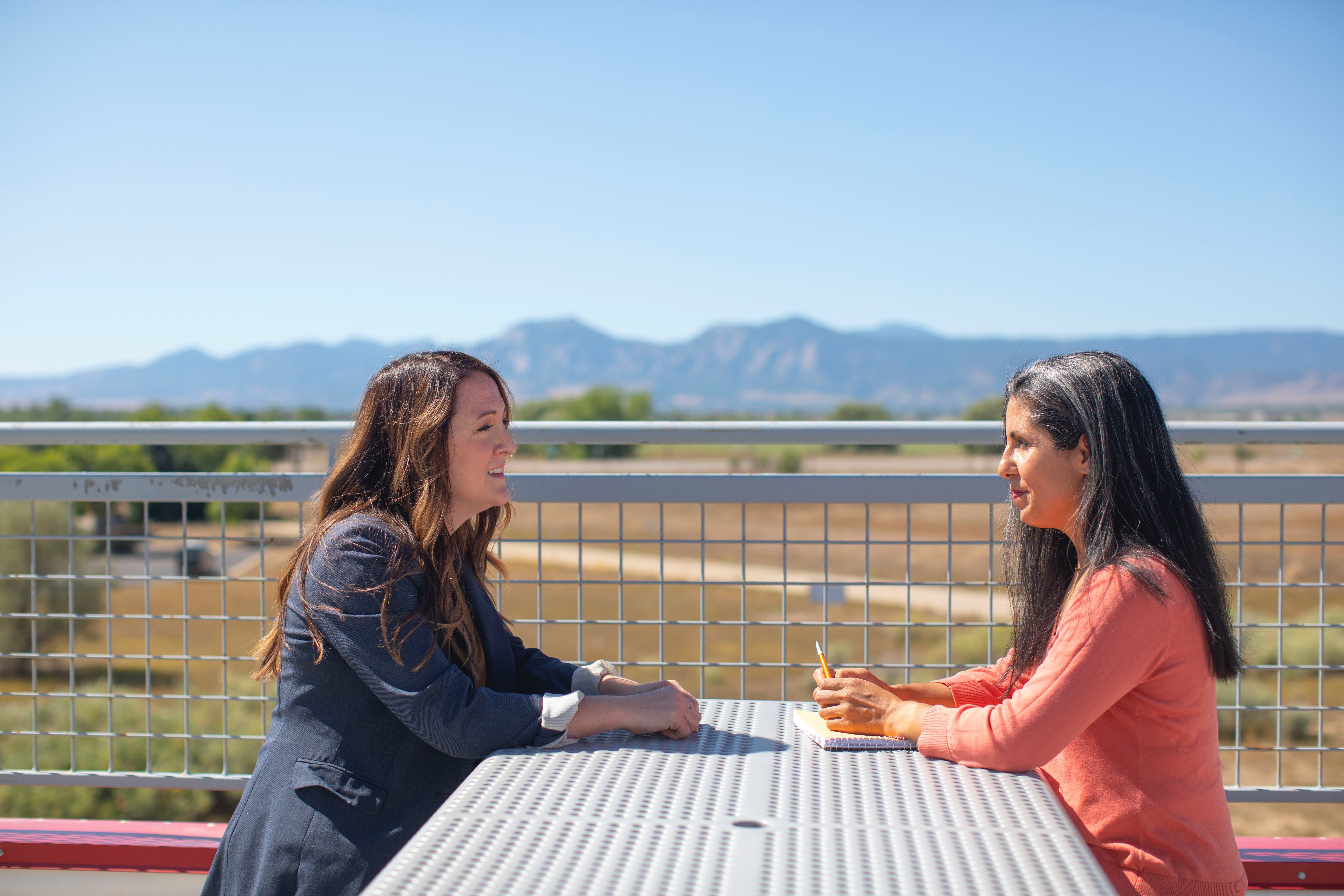 Two women sitting on a bench | Source: Unsplash / LinkedIn Sales Solutions