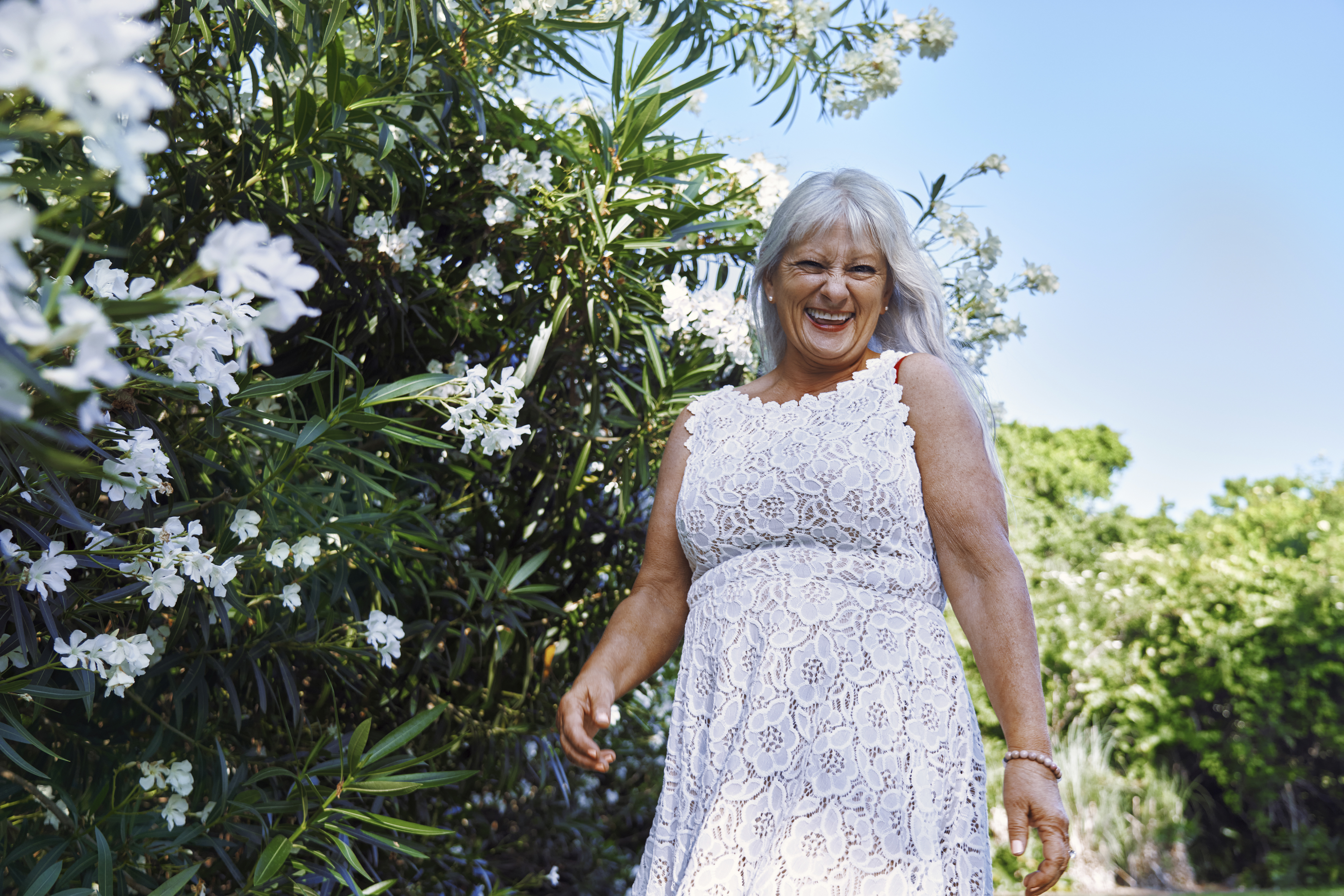 Happy senior woman in a white dress | Source: Getty Images