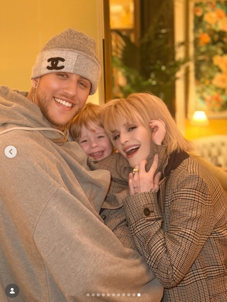 A second shot from inside The Dorchester sees Langford and Osbourne pulling the toddler close between them, all three of them breaking into broad grins at once. Osbourne, dressed in a checked blazer, rested her hand on her son's shoulder as Langford wrapped an arm around him from the other side. | Source: Instagram/kellyosbourne