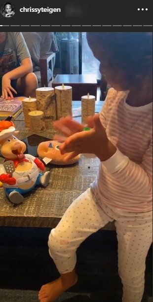 Chrissy Teigen shared a picture of her daughter, Luna Legend playing The Goliath Pop the Pig With Bonus 24pc/Puzzle game |Source: Instagram.com/chrissyteigen