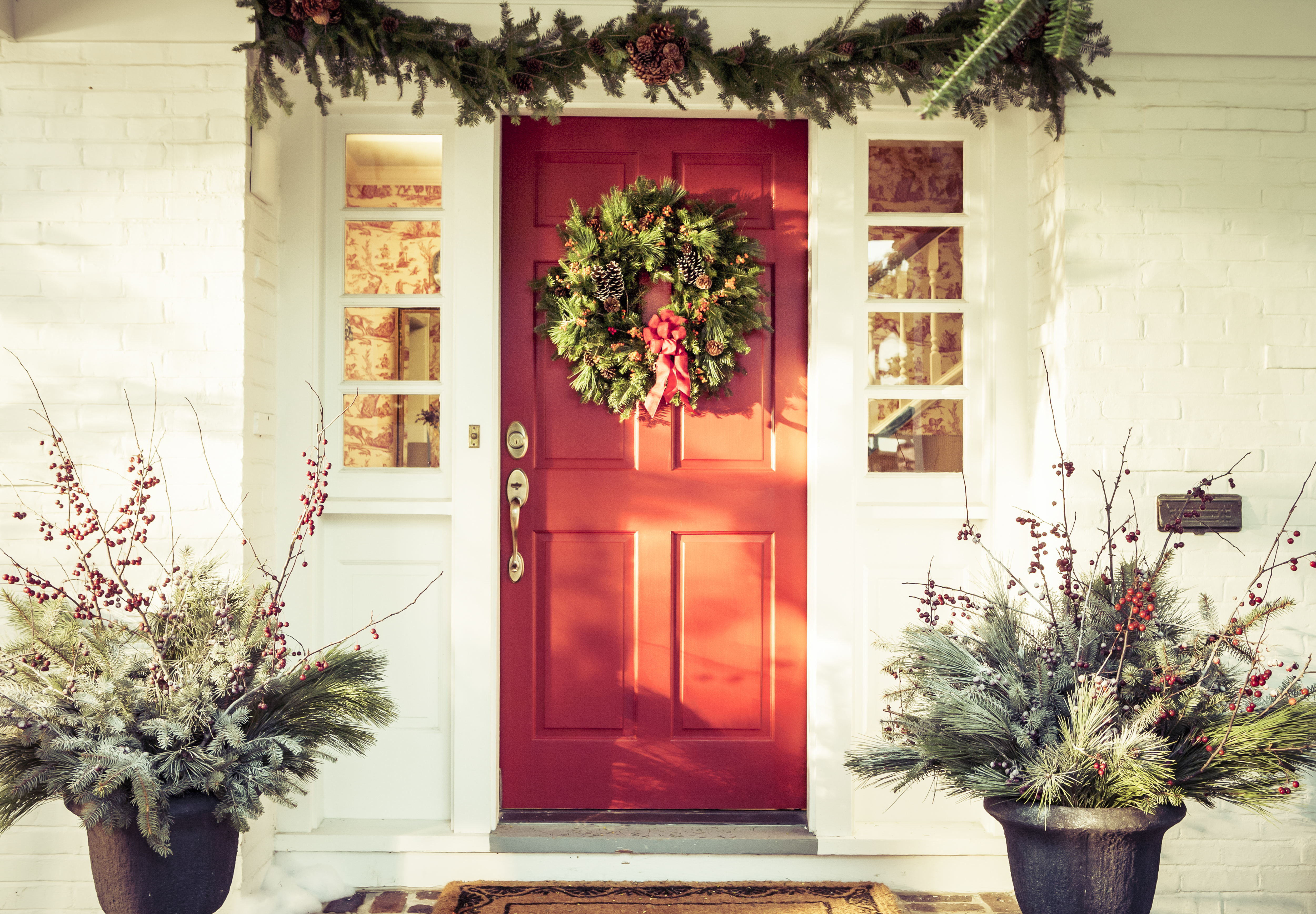 A red door decorated for Christmas. | Source: Getty Images