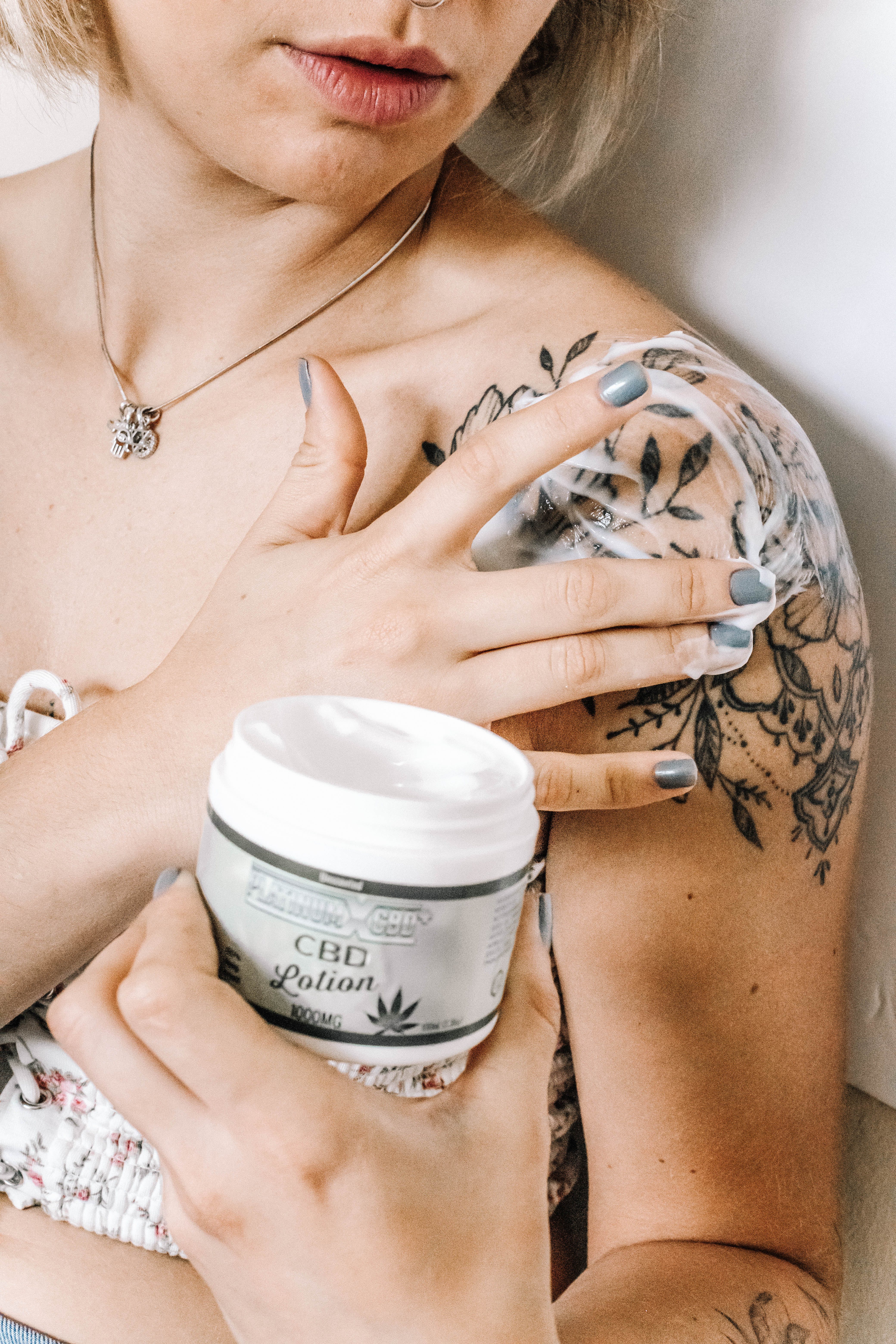 A woman taking care of a new tattoo | Source: Pexels