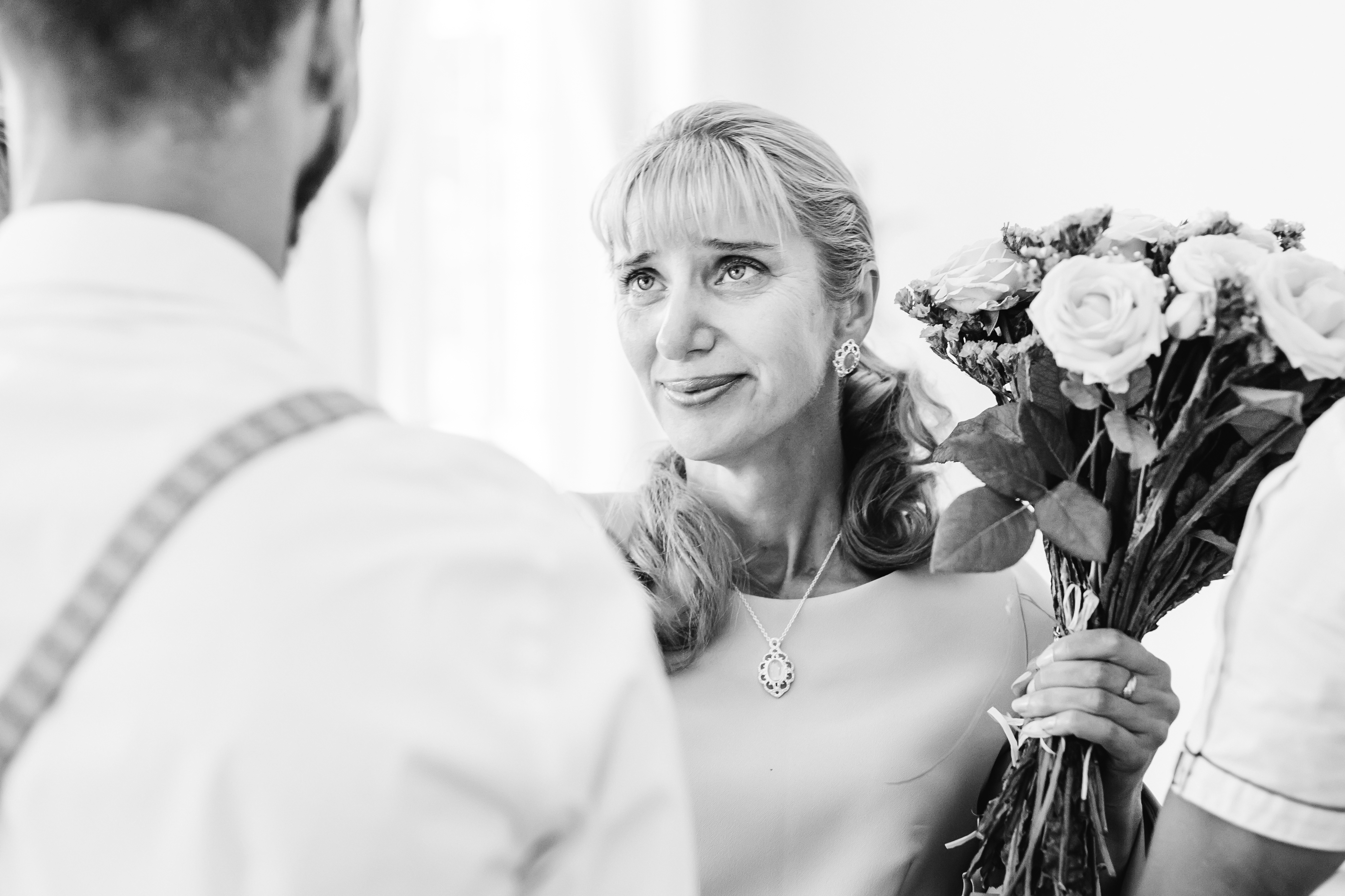 An older woman talking to a young man at a wedding | Source: Shutterstock